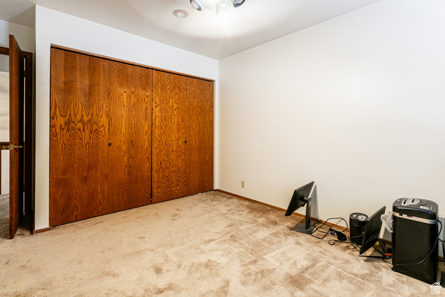 Unfurnished bedroom featuring light colored carpet and a closet