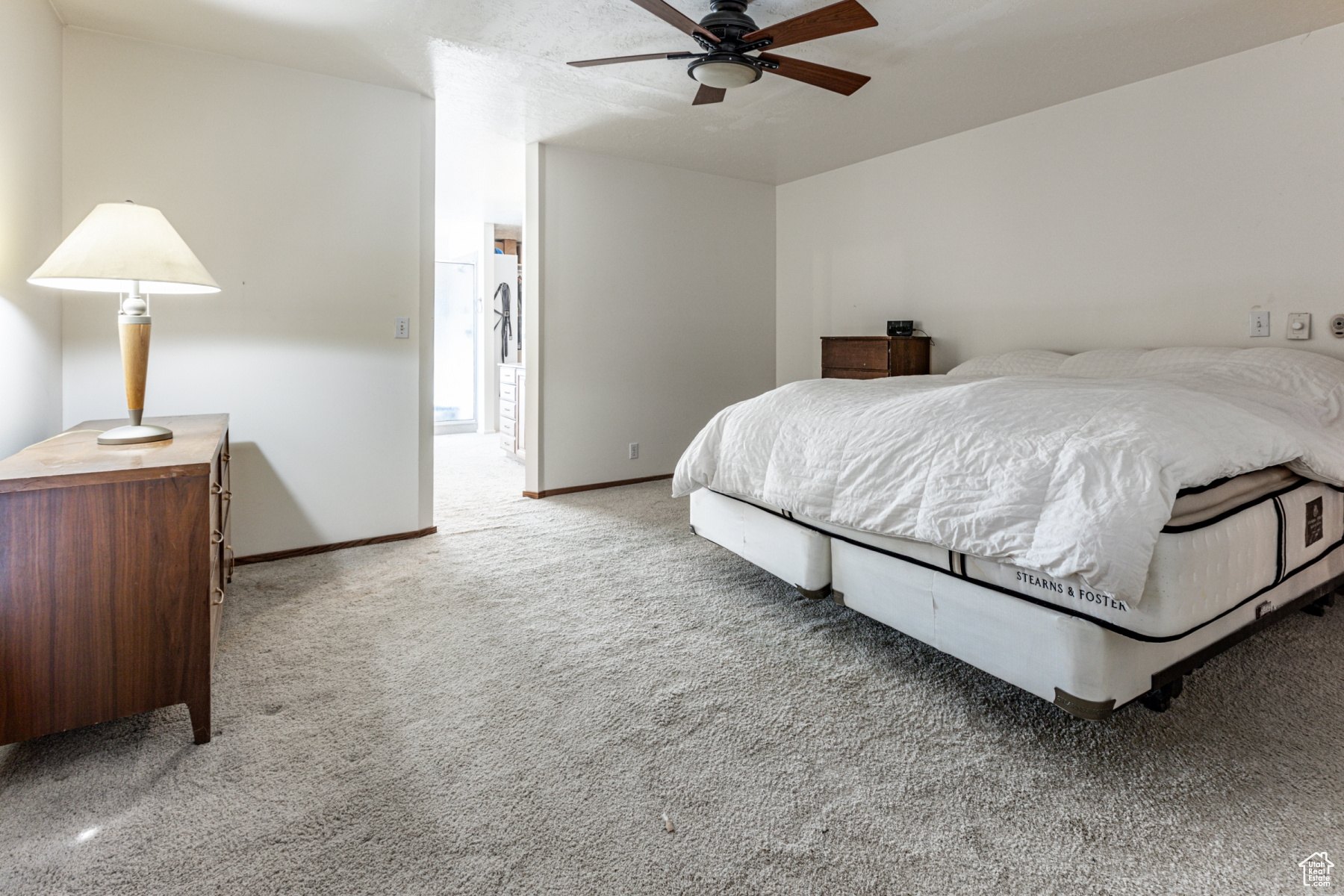 Bedroom with ceiling fan and carpet floors