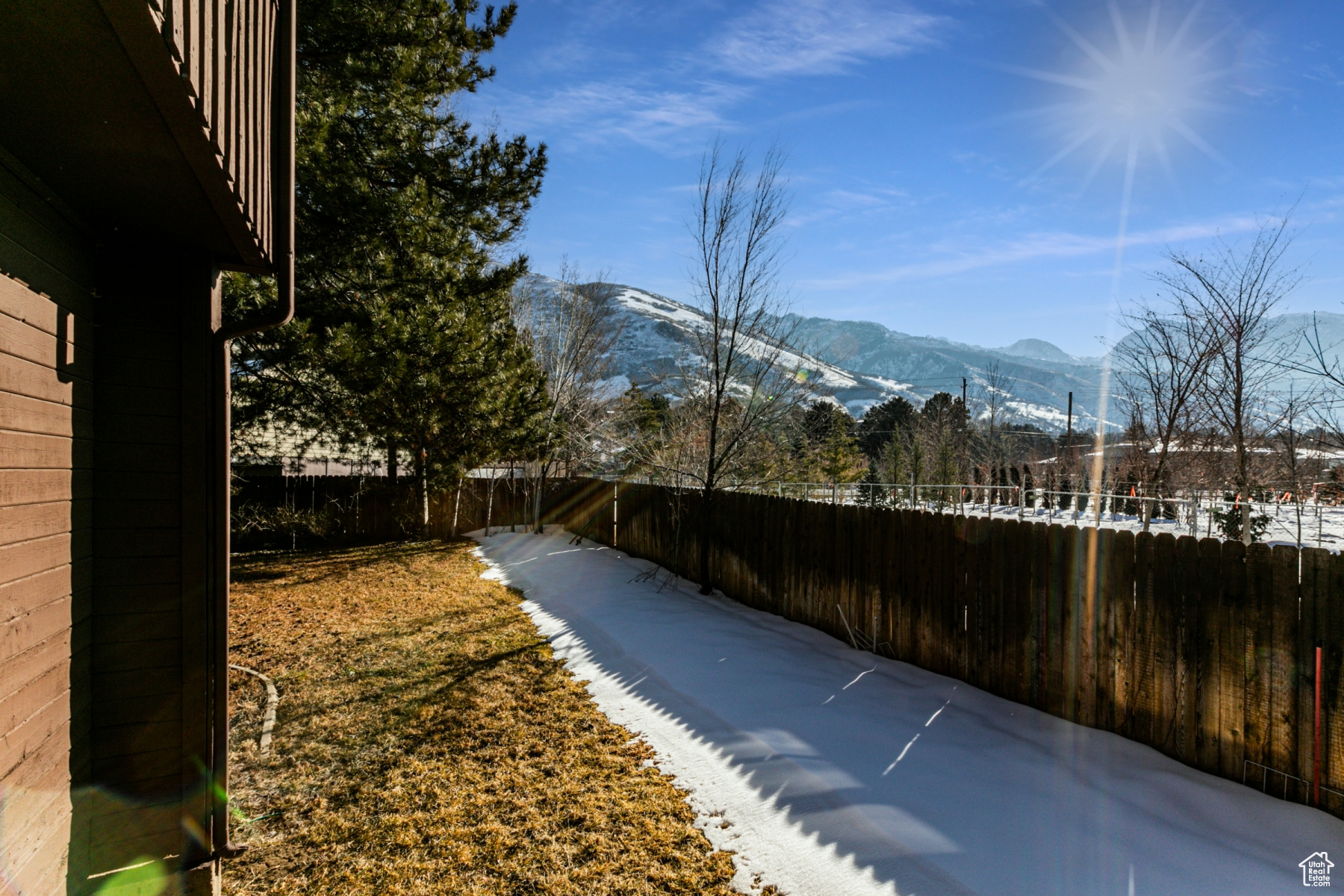 Yard layered in snow featuring a mountain view