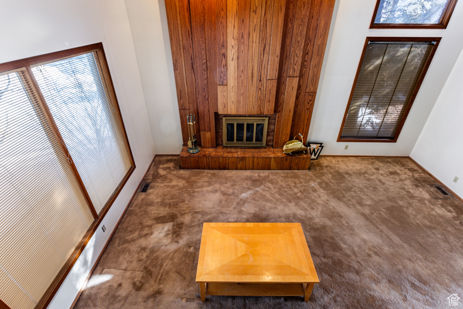 Unfurnished living room featuring dark carpet