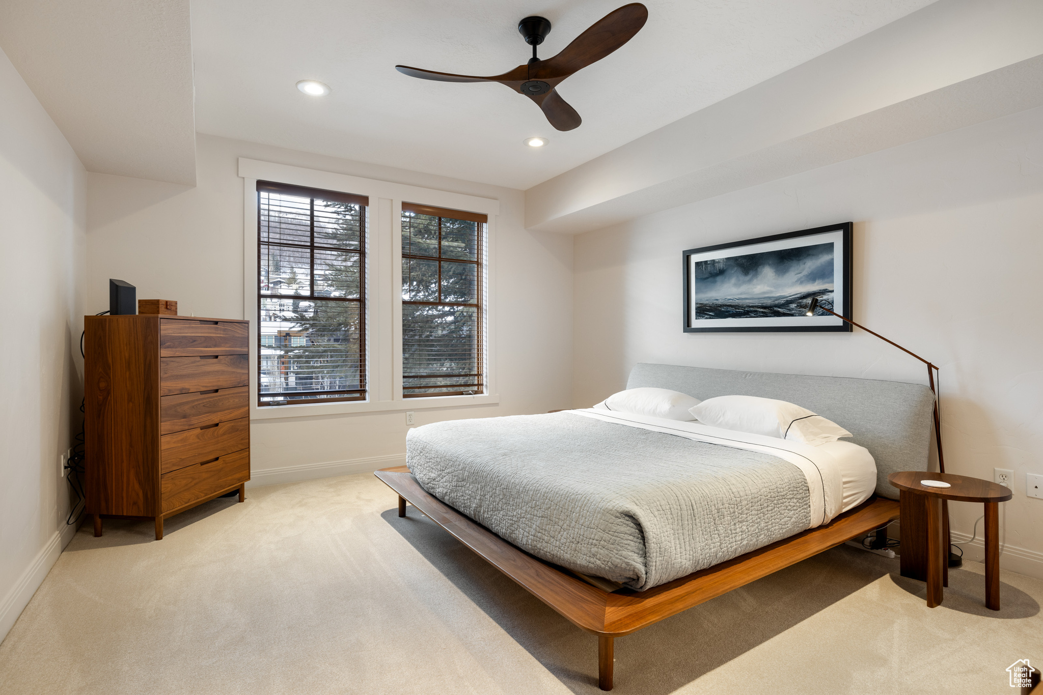 Carpeted bedroom featuring ceiling fan