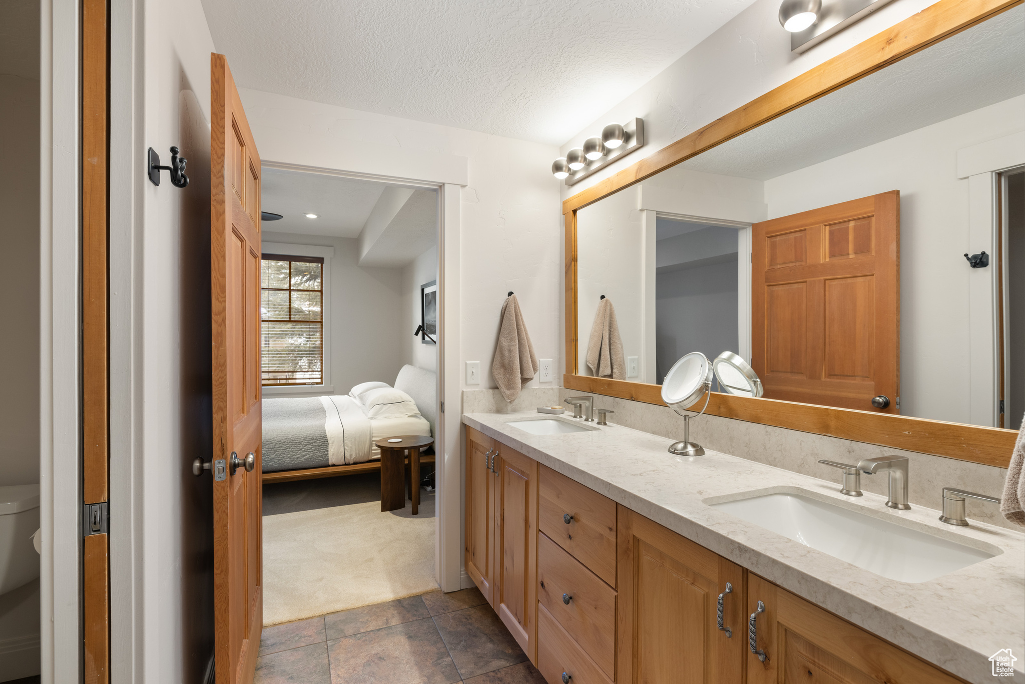 Bathroom featuring vanity, a textured ceiling, and toilet