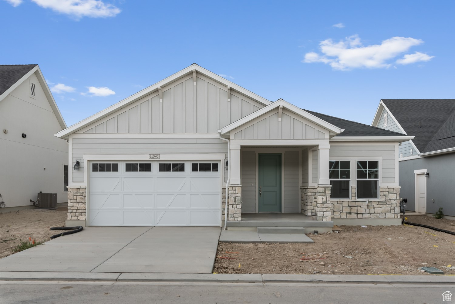 Craftsman inspired home featuring a garage and central AC