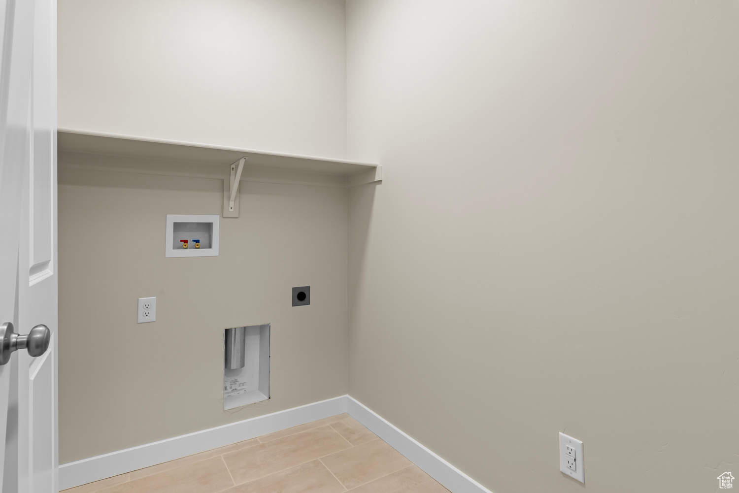 Laundry area featuring hookup for a washing machine, light tile patterned flooring, and hookup for an electric dryer