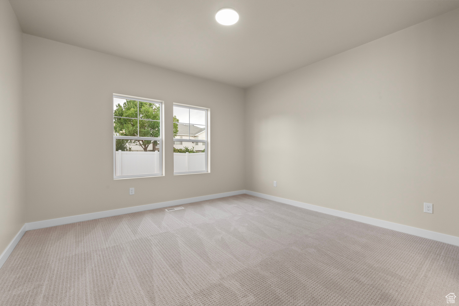 Unfurnished room with light carpet