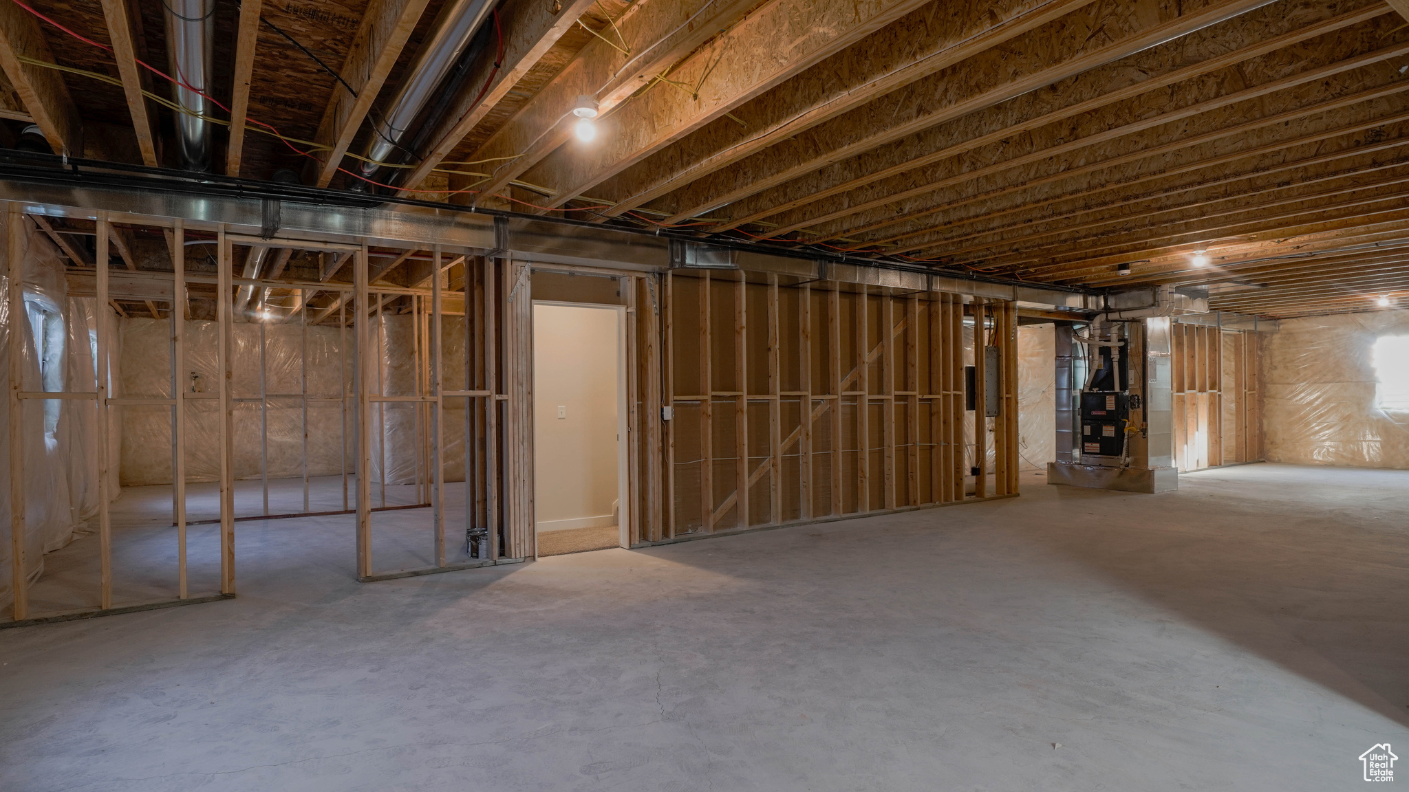 Unfinished basement featuring heating unit