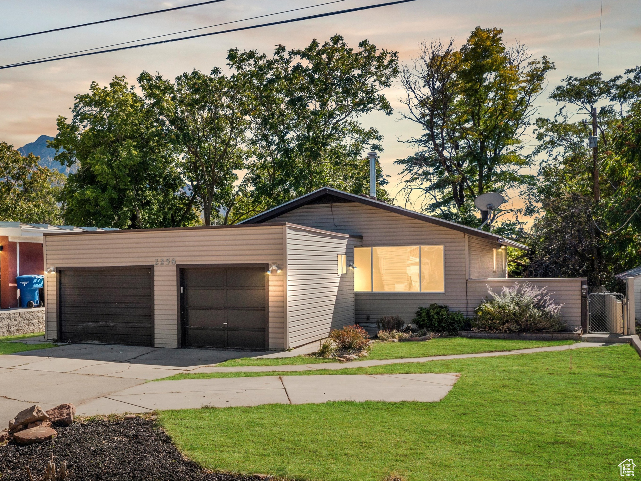 View of front of property featuring a garage and a lawn