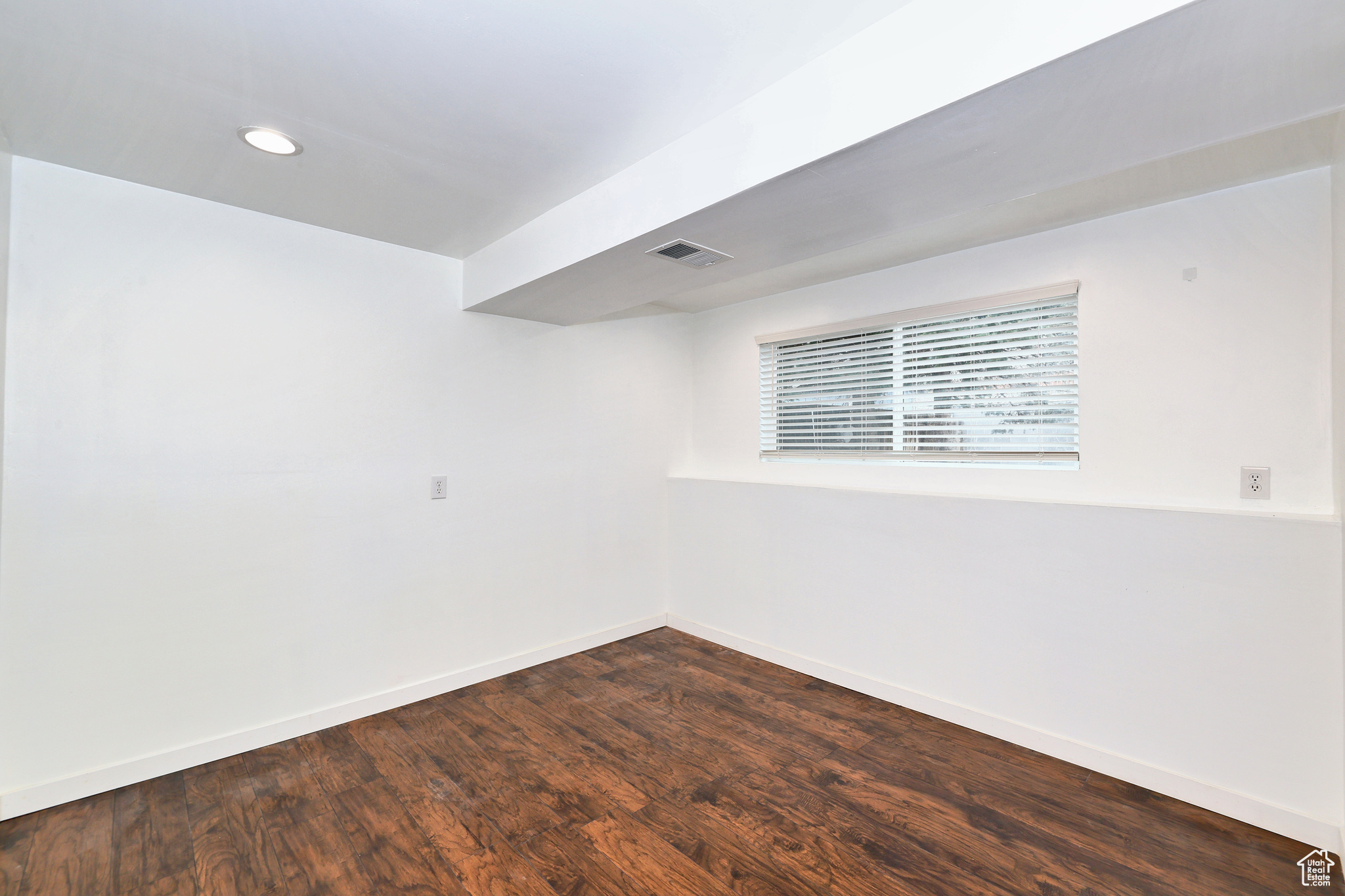 Empty room with dark hardwood / wood-style flooring