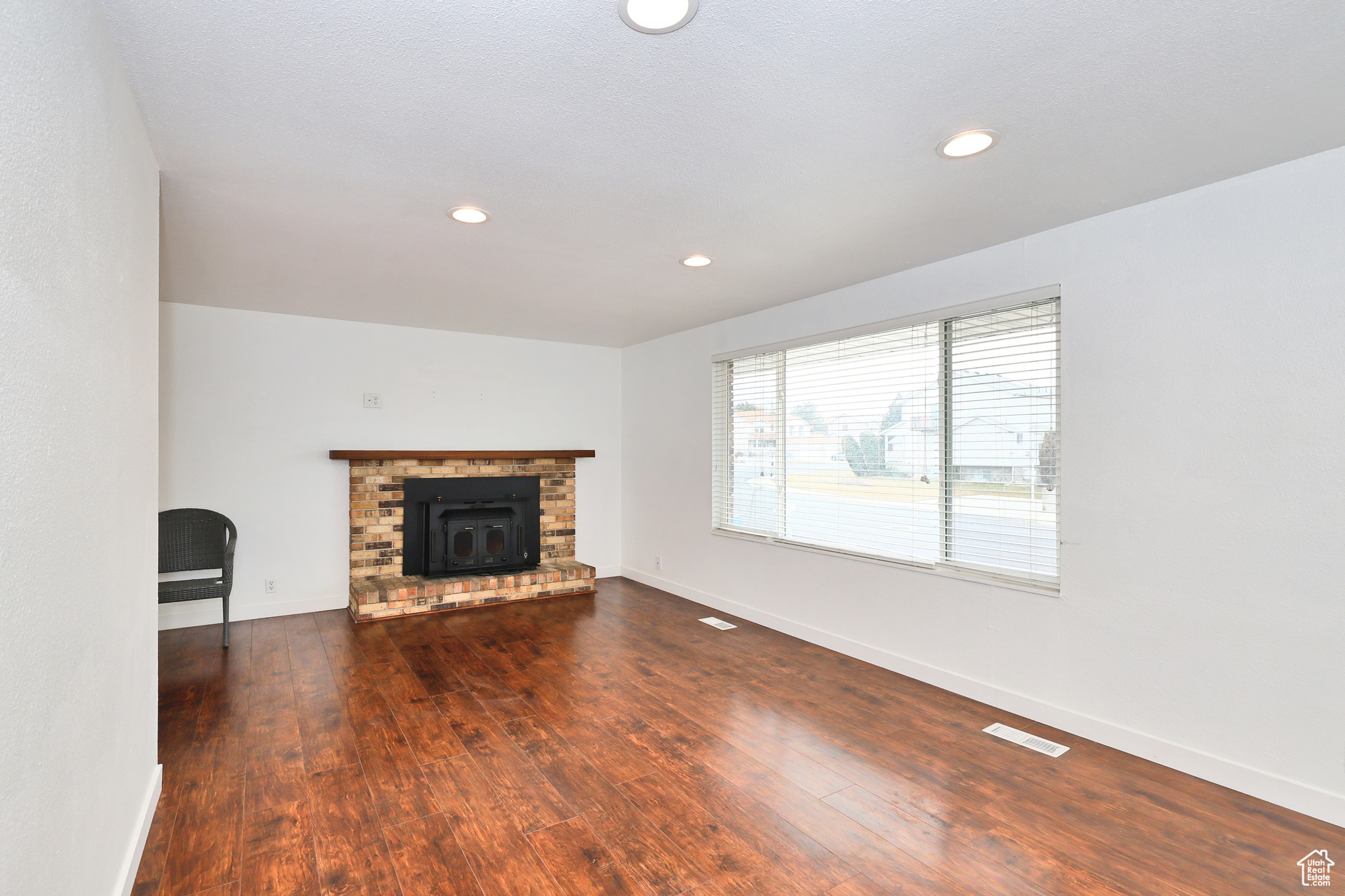 Unfurnished living room featuring dark hardwood / wood-style flooring