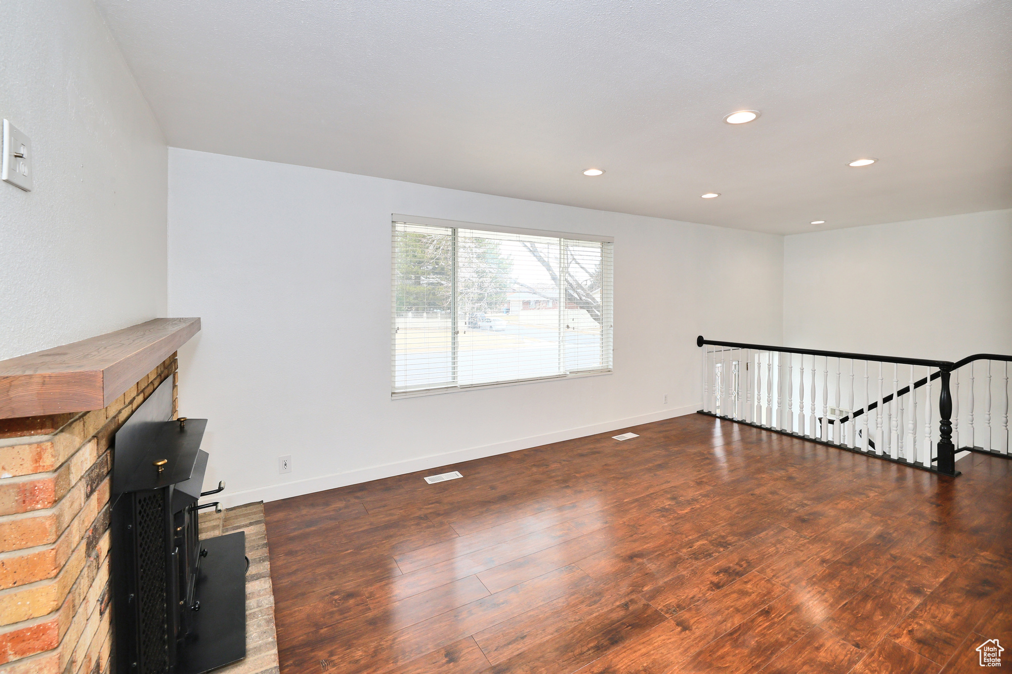 Unfurnished living room with dark hardwood / wood-style flooring