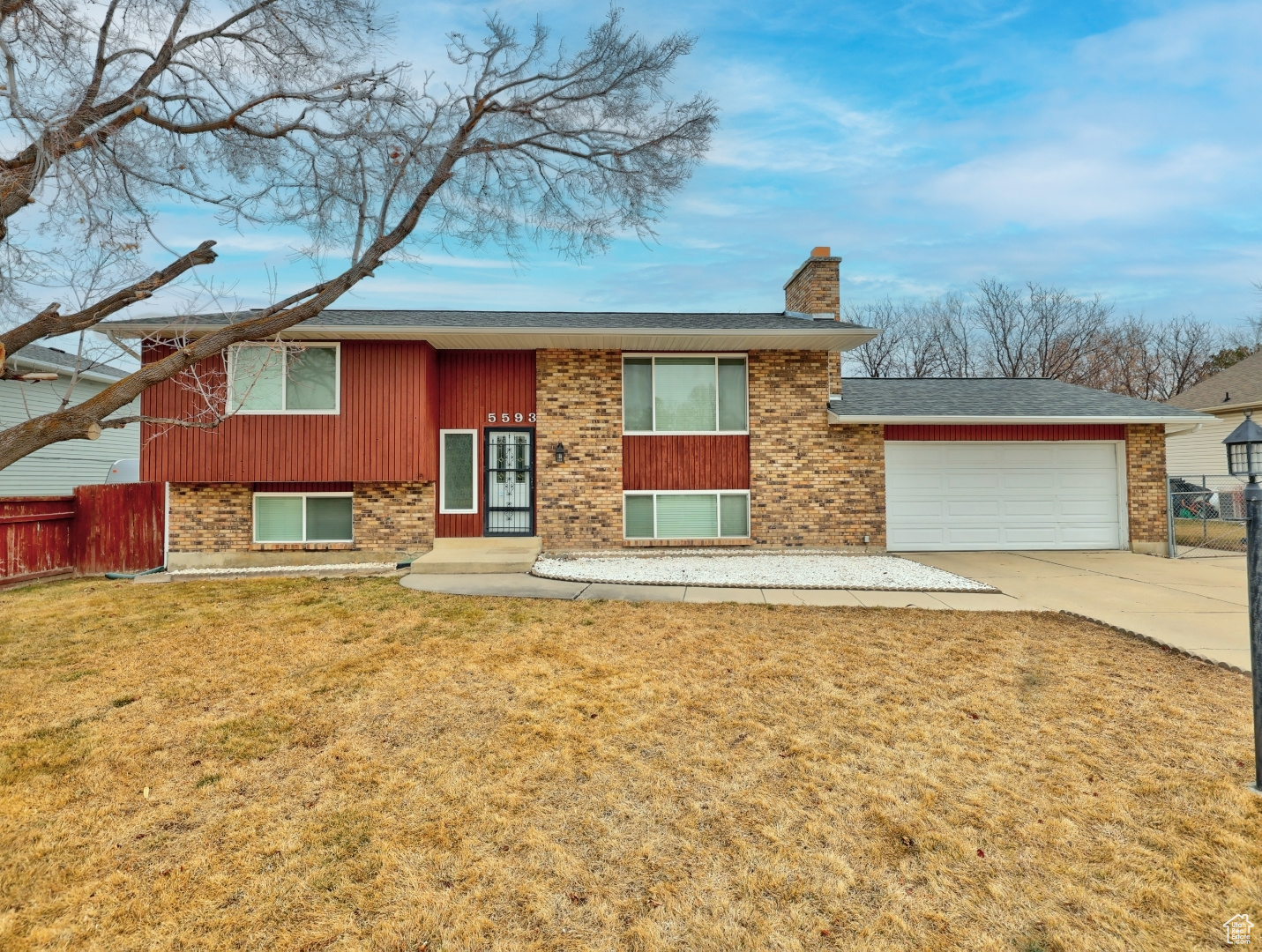 Raised ranch with a garage and a front yard