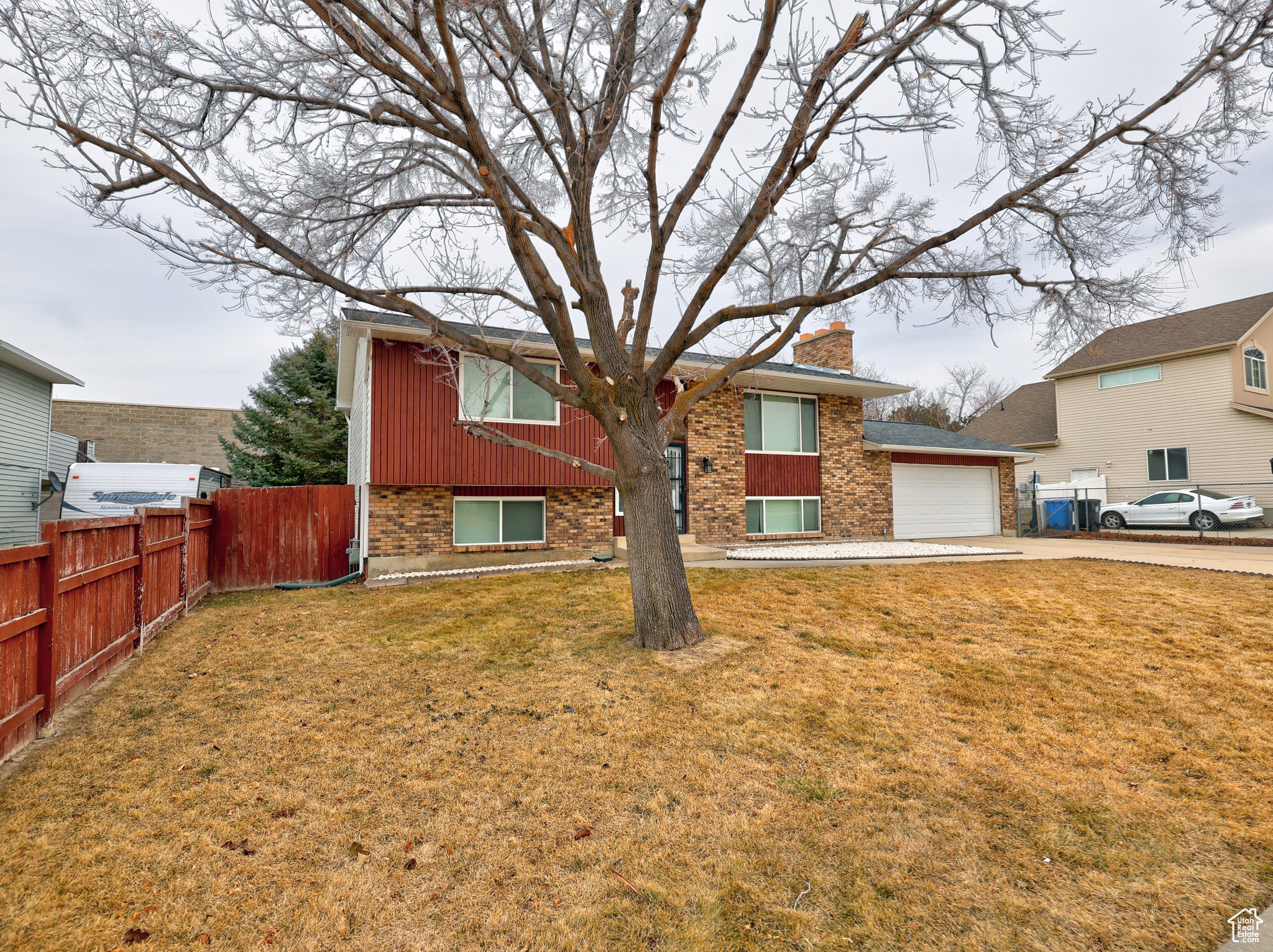 View of front of house featuring a garage and a front yard