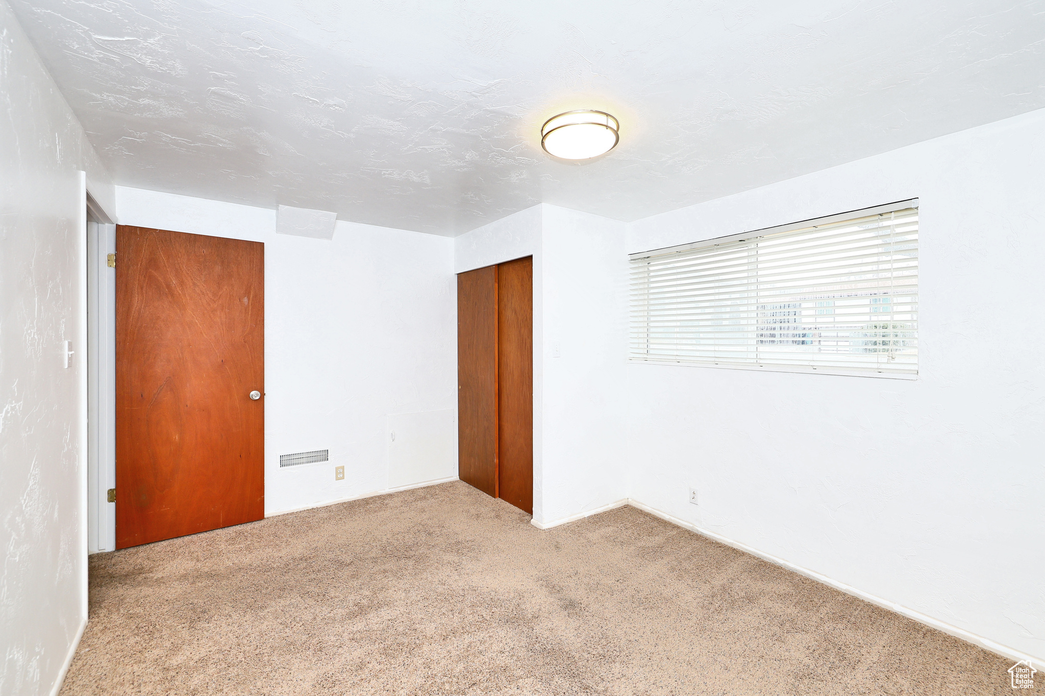 Unfurnished room with light carpet