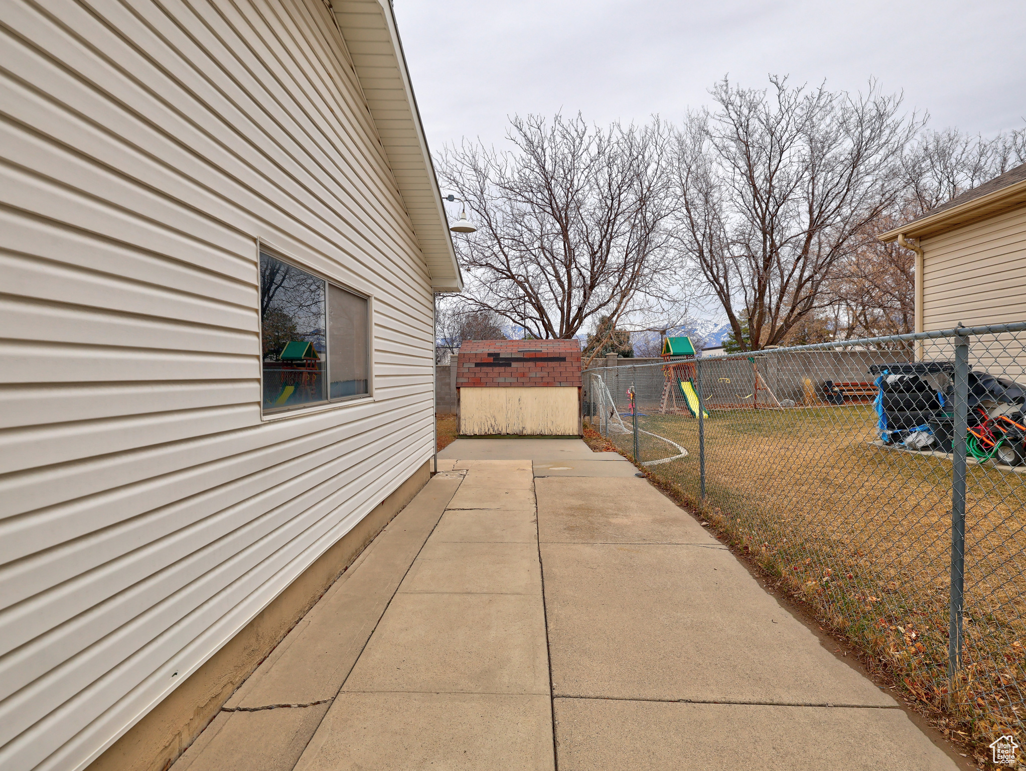 Exterior space featuring a yard, a playground, and a patio