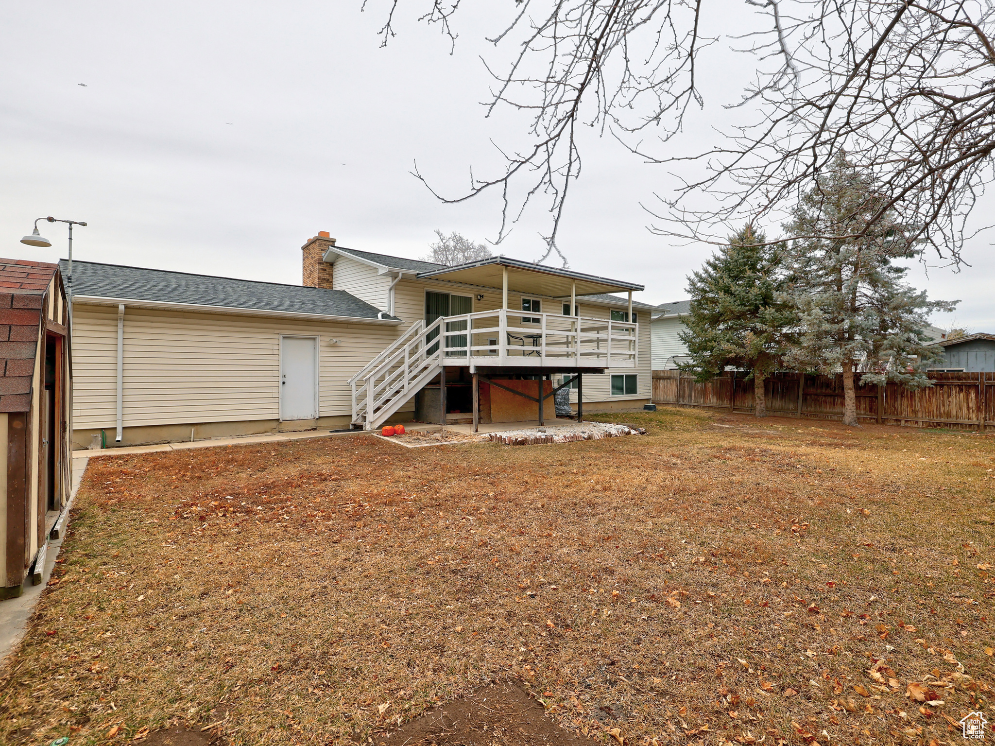 Rear view of property featuring a wooden deck