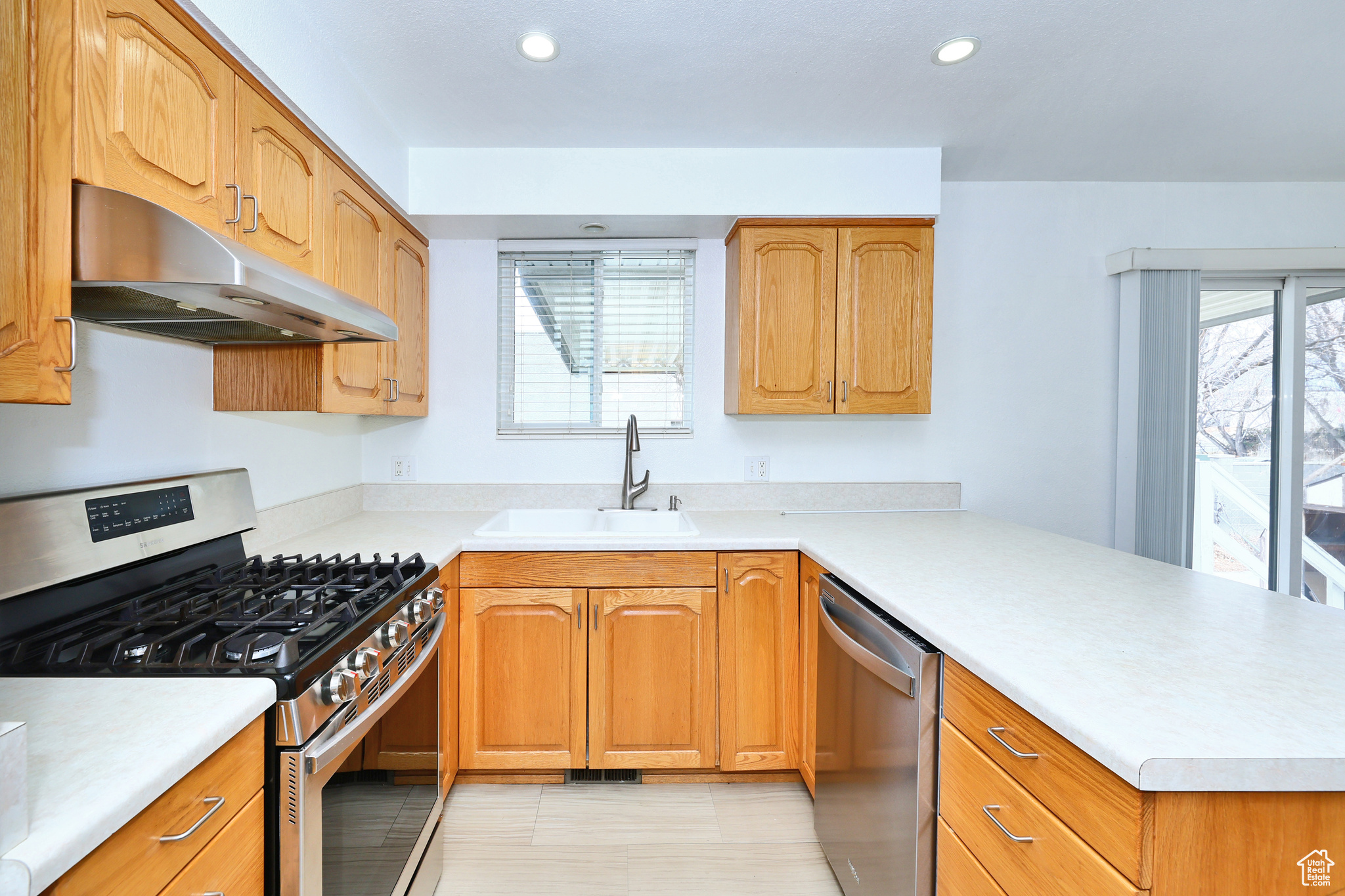 Kitchen with stainless steel appliances, sink, and kitchen peninsula