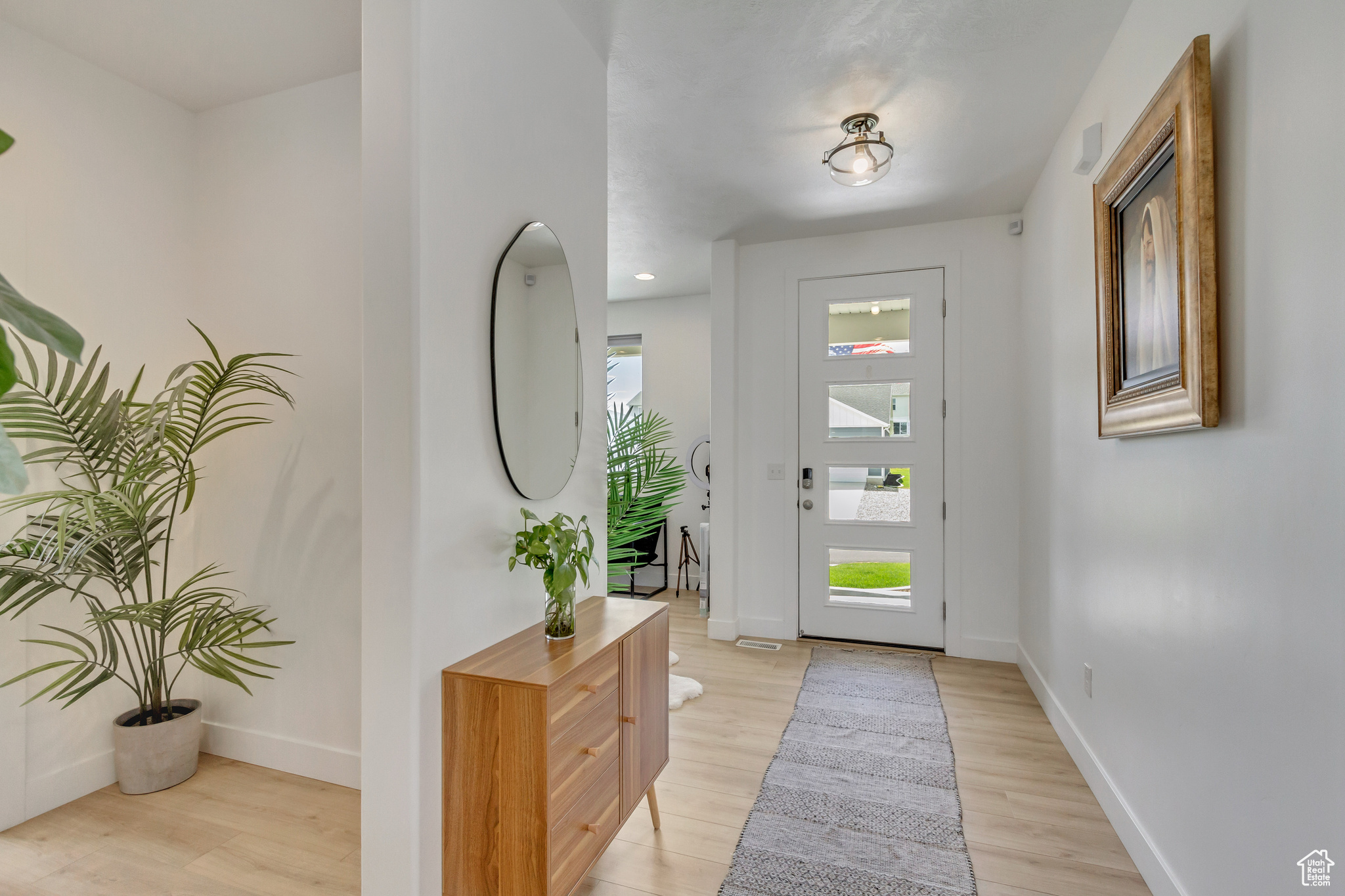 Foyer entrance with light wood-type flooring