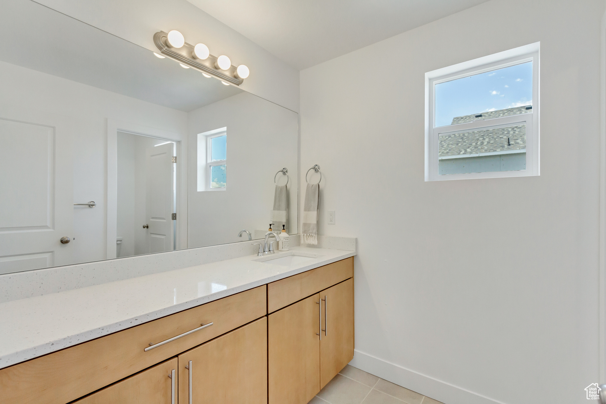 Bathroom with vanity and tile patterned floors