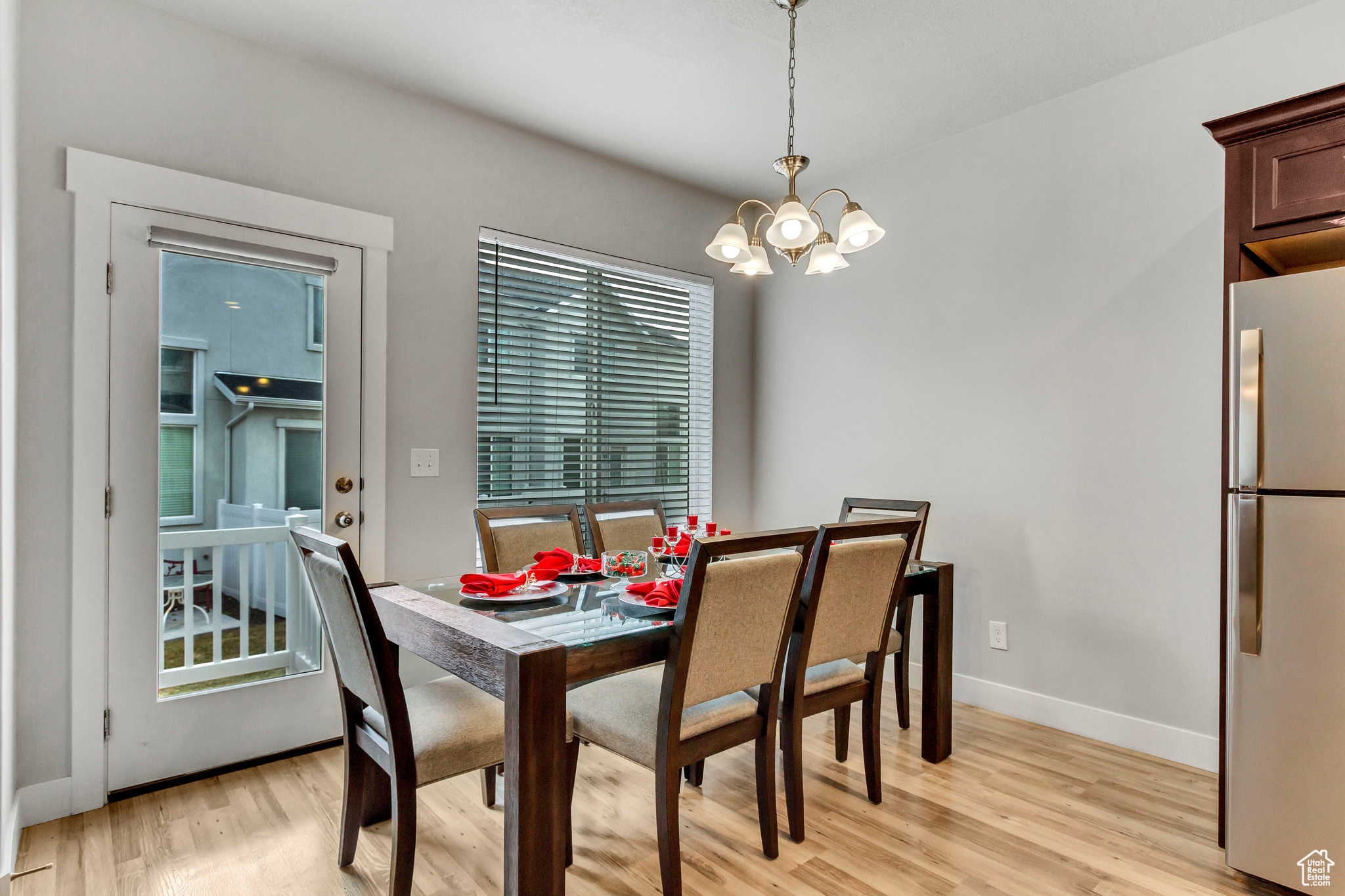 Dining area featuring an inviting chandelier and light wood-type flooring