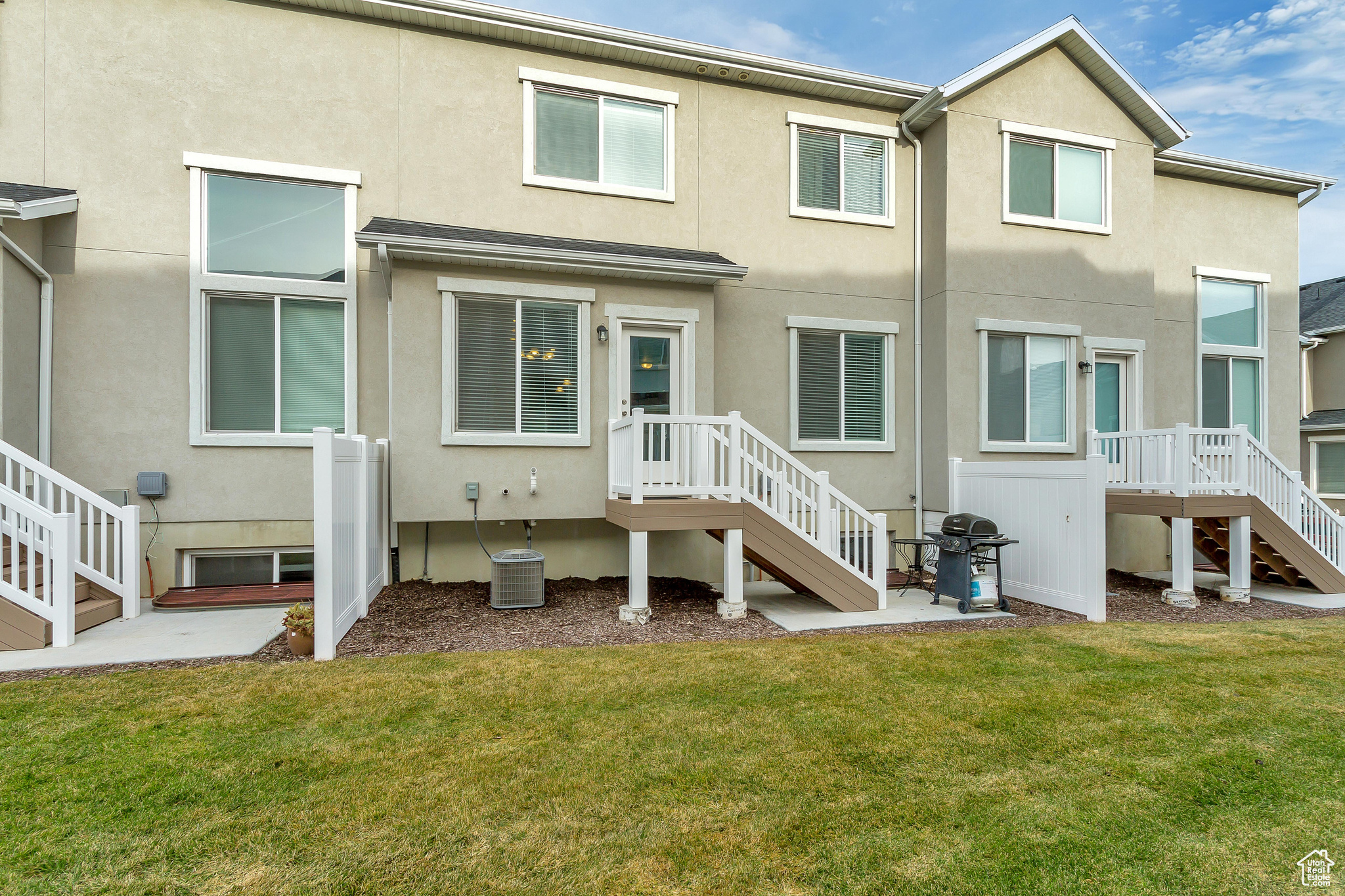 Back of property featuring a yard and central air condition unit