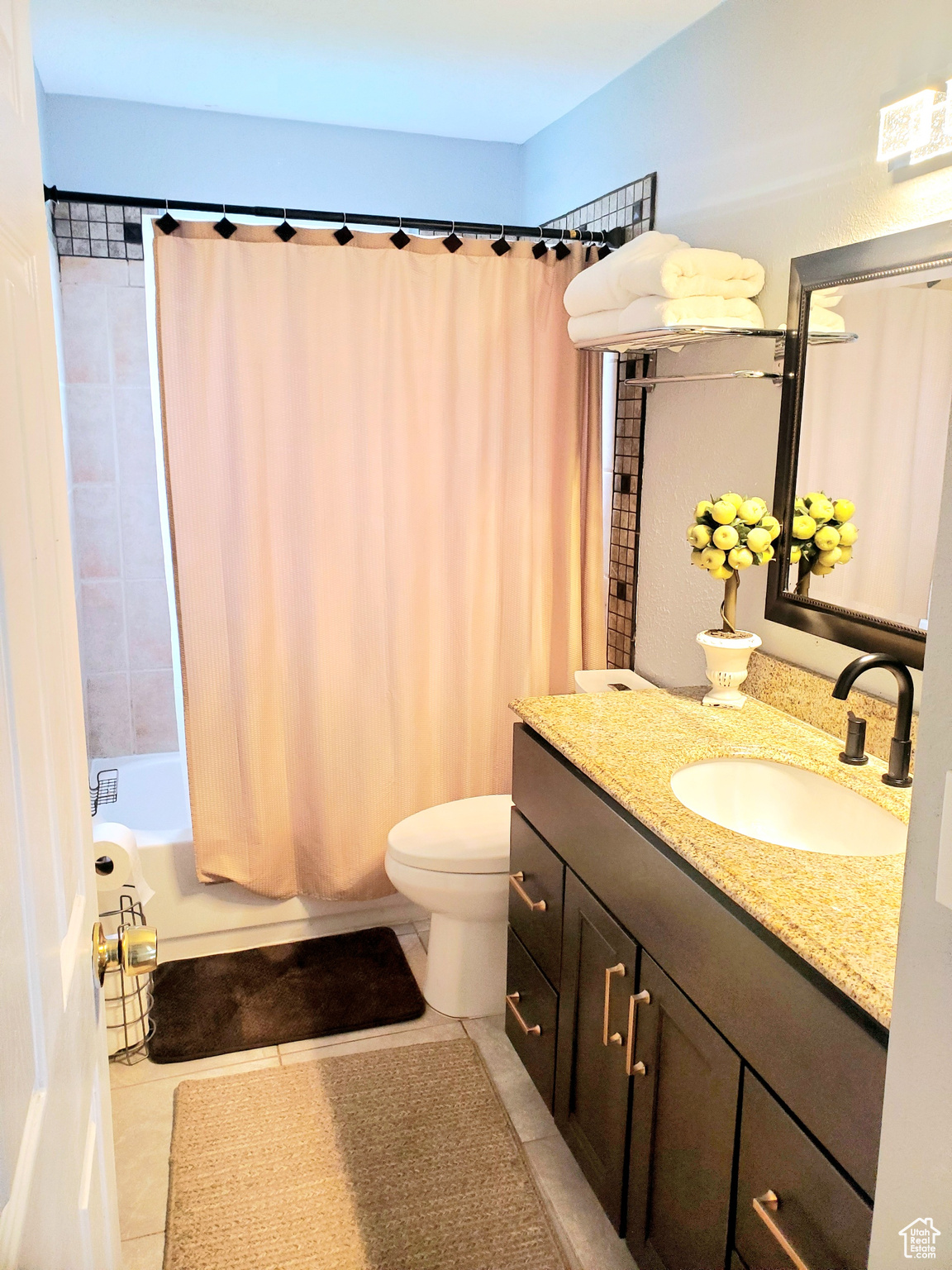 Full bathroom with tile patterned flooring, vanity, shower / bath combination with curtain, and toilet