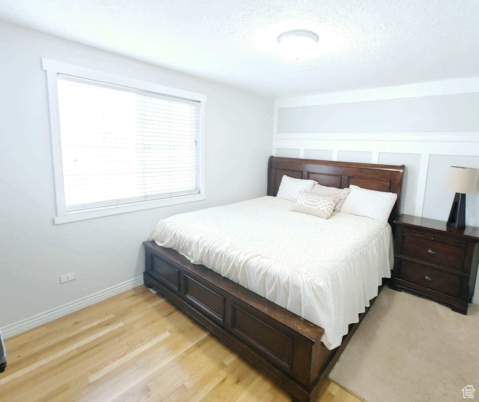 Bedroom with a textured ceiling and light wood-type flooring