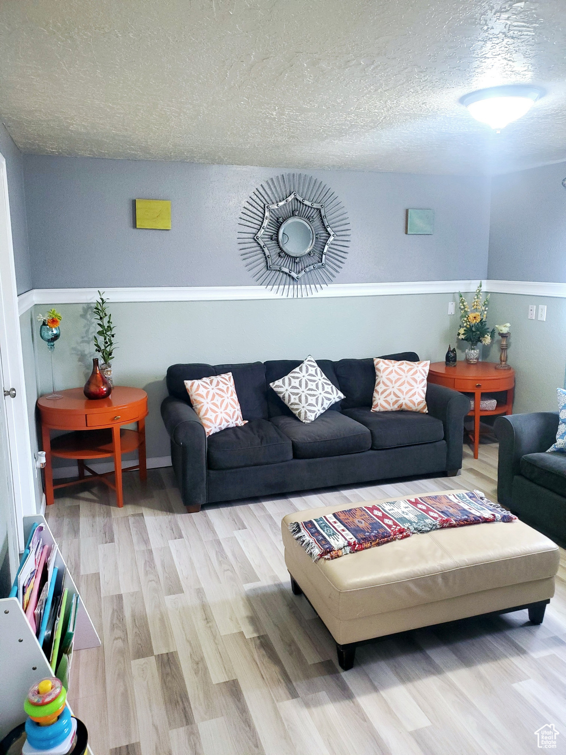 Living room with hardwood / wood-style floors and a textured ceiling