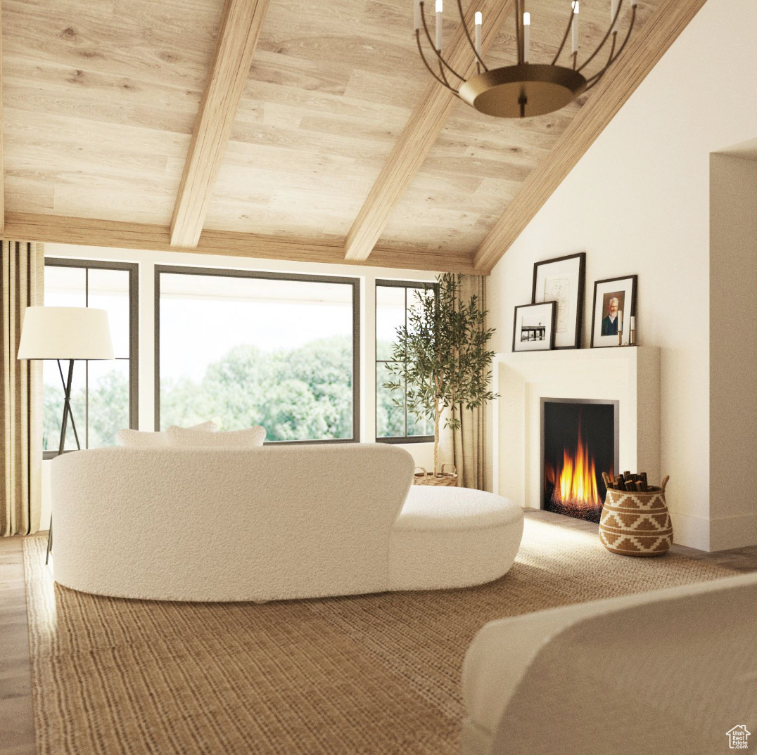 Primary bedroom sitting area featuring lofted ceiling with beams, carpet, and wooden ceiling