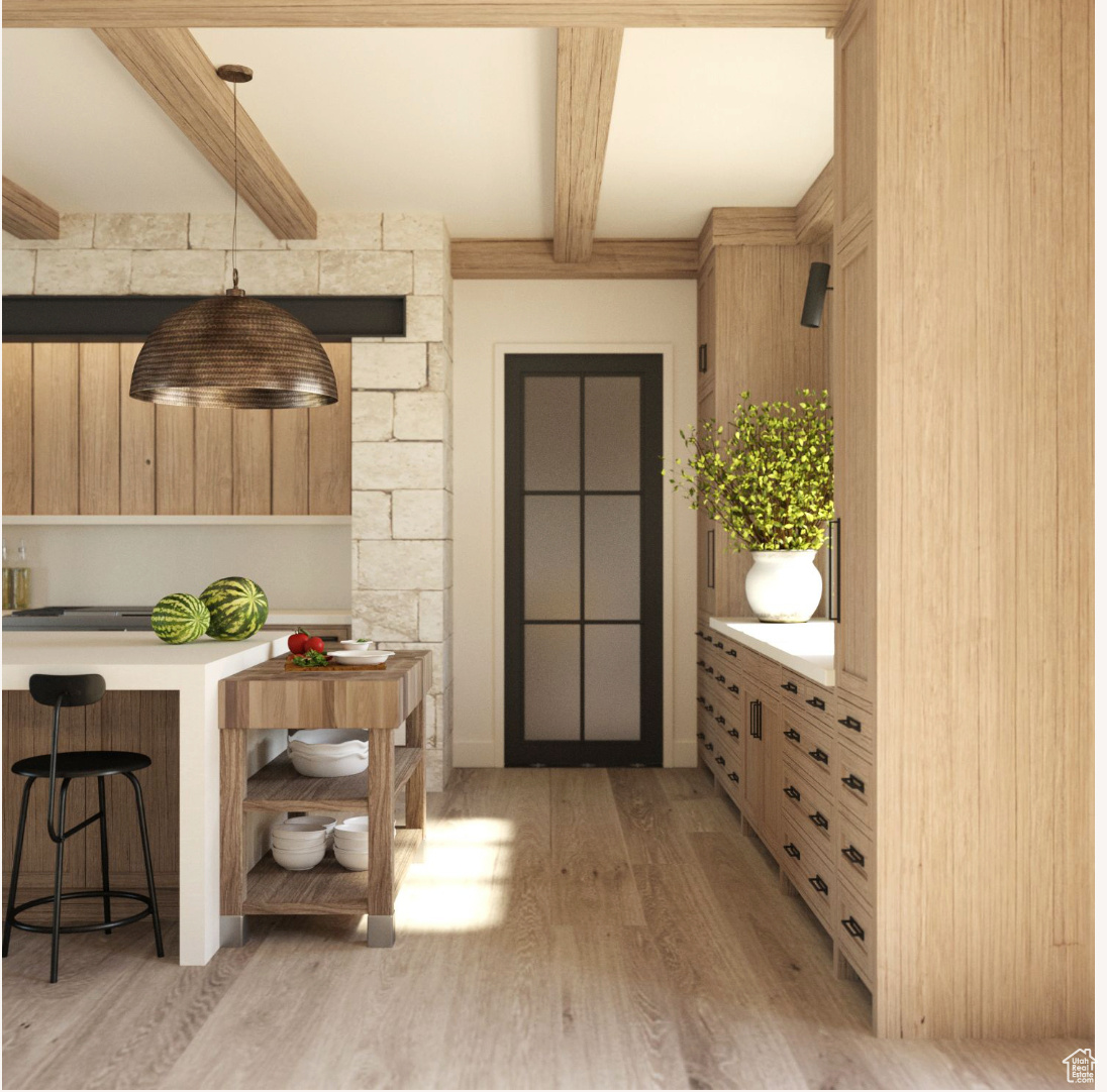 Interior space with beam ceiling and light hardwood / wood-style floors