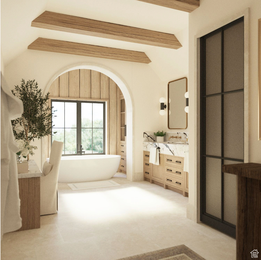 Primary Bathroom with vanity, a bath, and lofted ceiling with beams