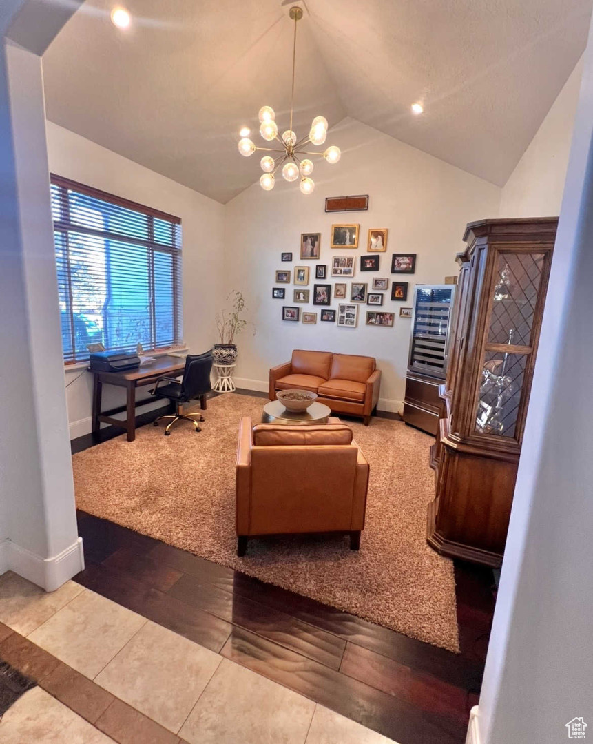 Living room featuring lofted ceiling and a chandelier