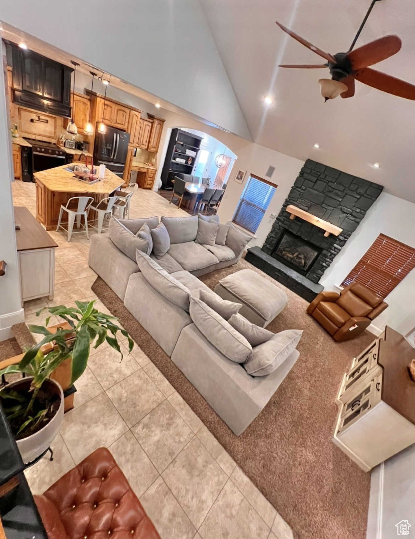 Tiled living room featuring sink, high vaulted ceiling, and ceiling fan