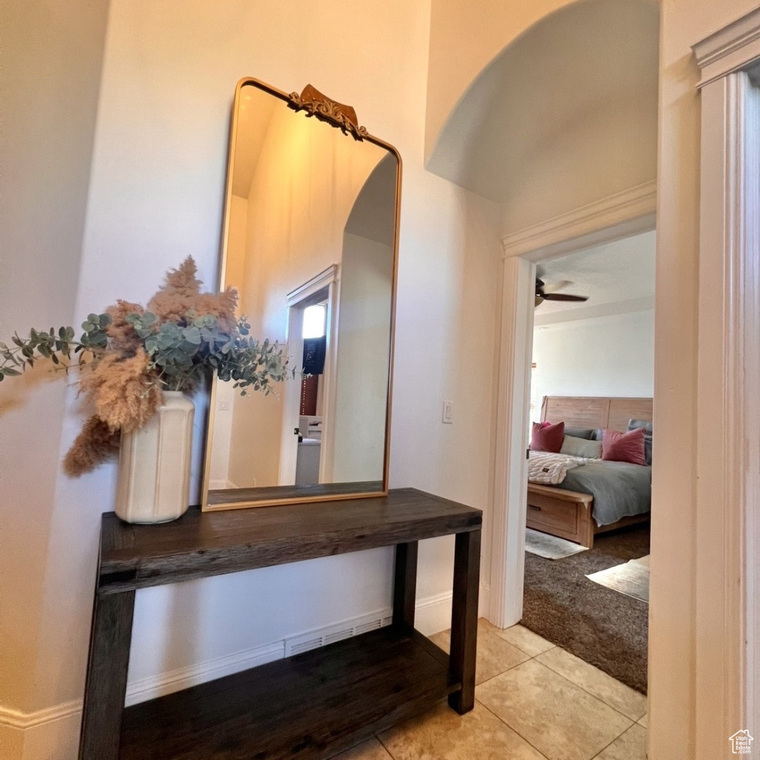 Hallway with light tile patterned floors