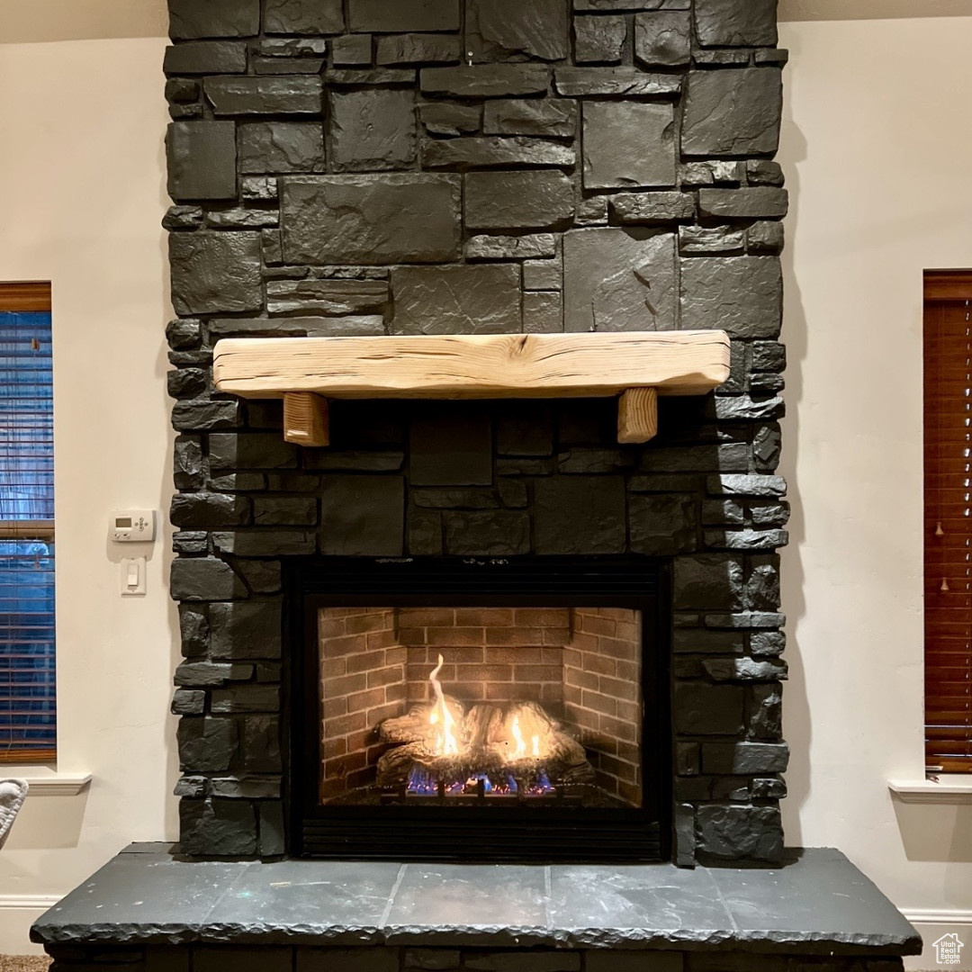 Interior details featuring a stone fireplace