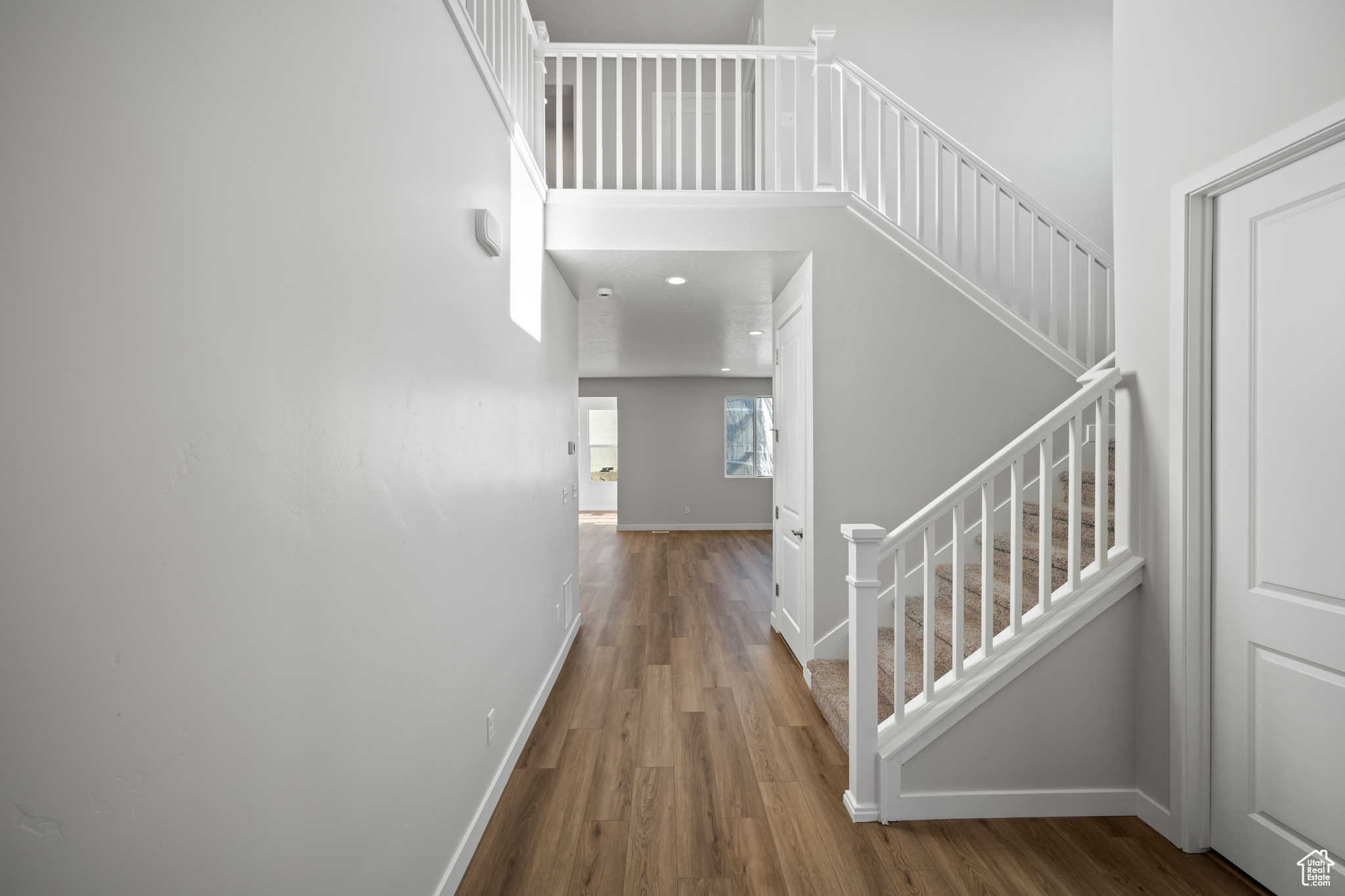 Interior space featuring wood-type flooring and a high ceiling