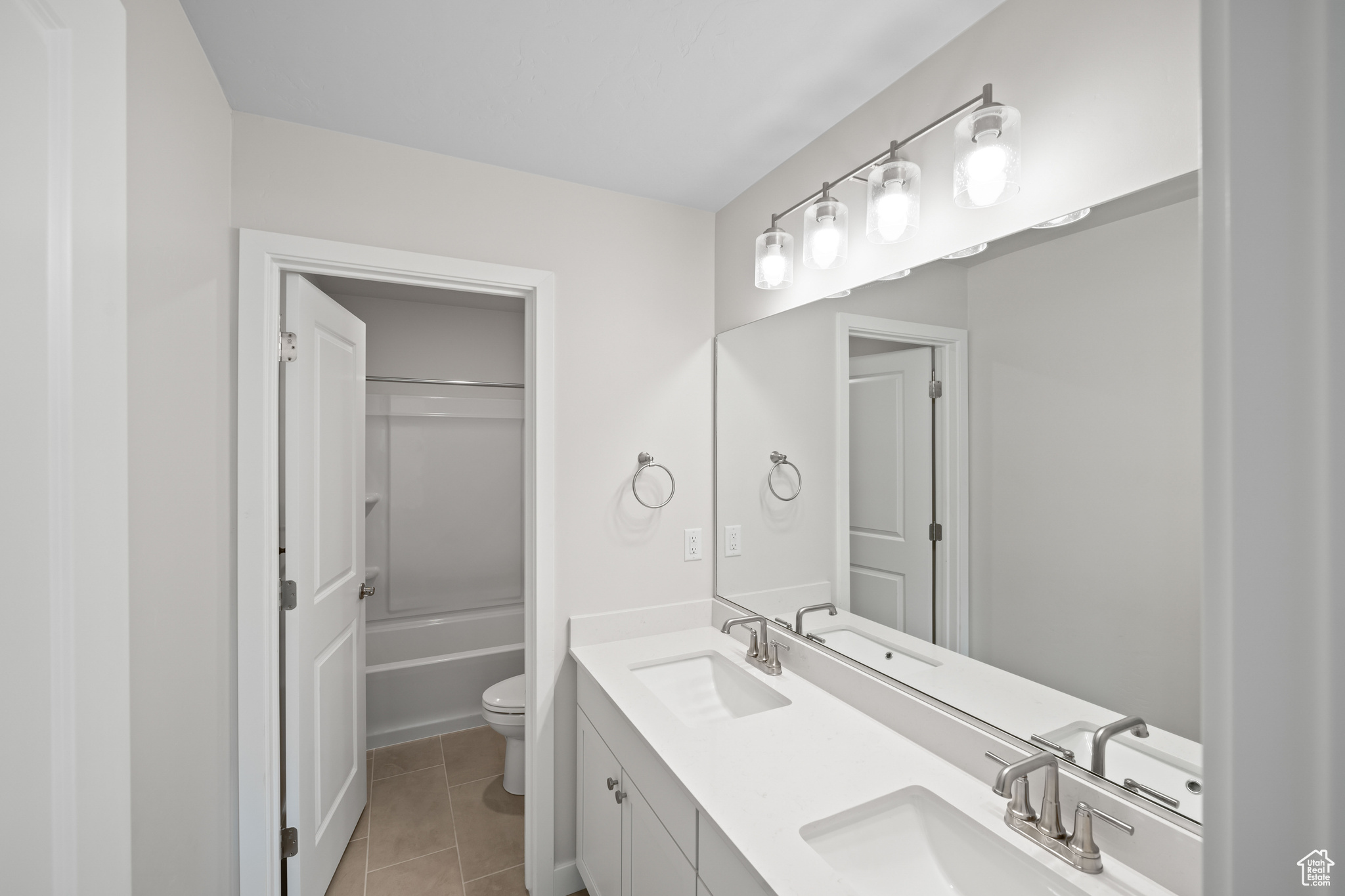 Bathroom with tile patterned flooring, vanity, and toilet