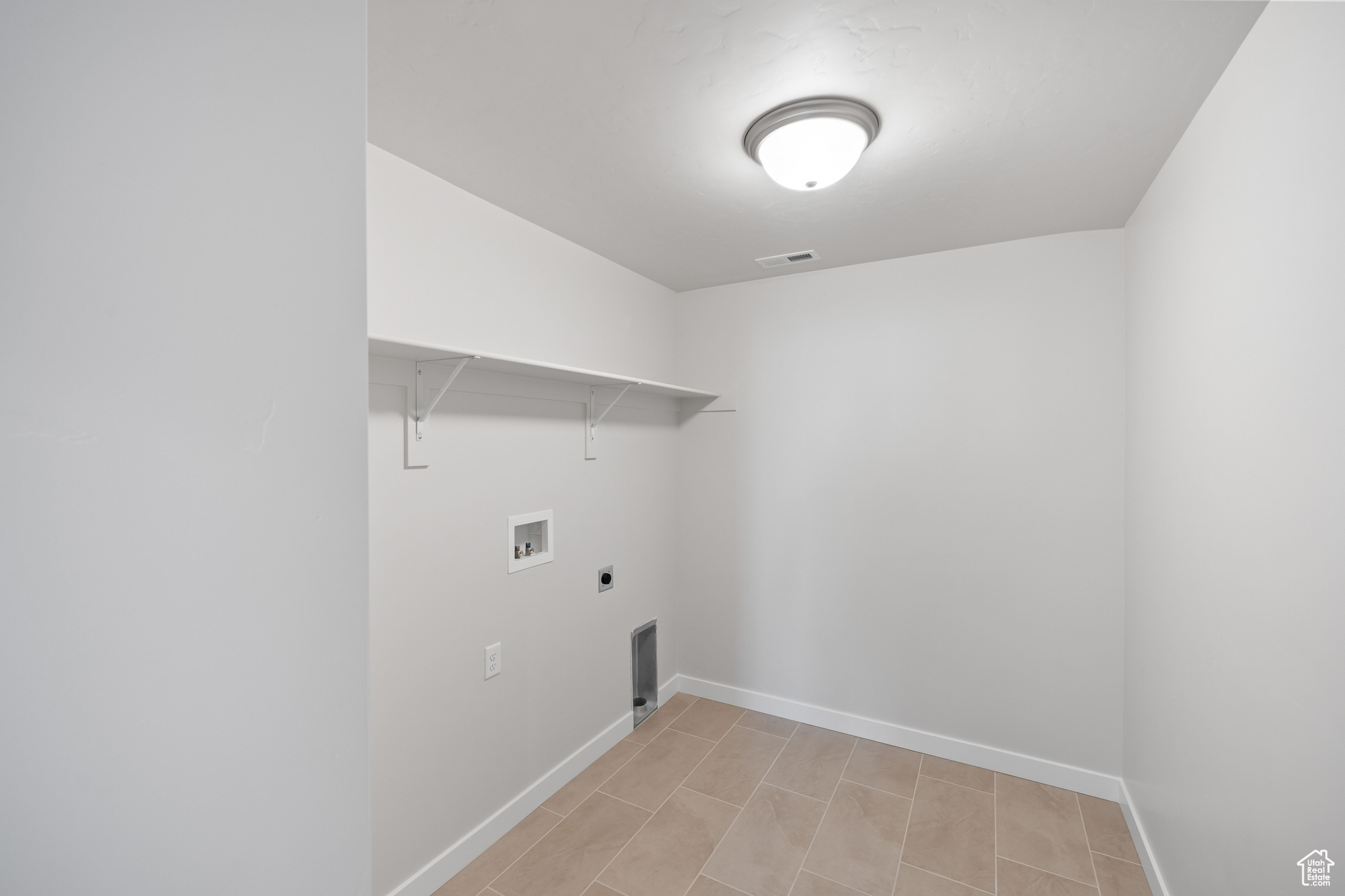 Laundry area with hookup for a washing machine and hookup for an electric dryer