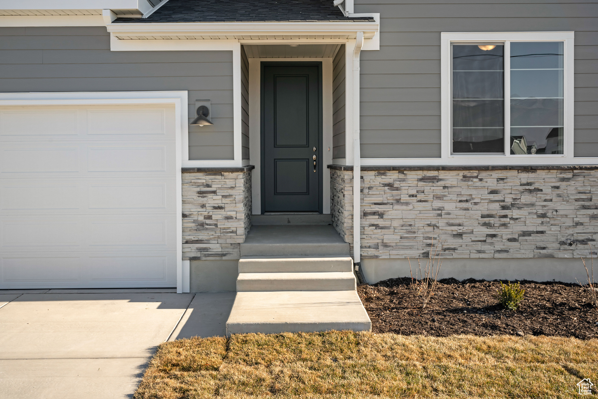 View of exterior entry featuring a garage