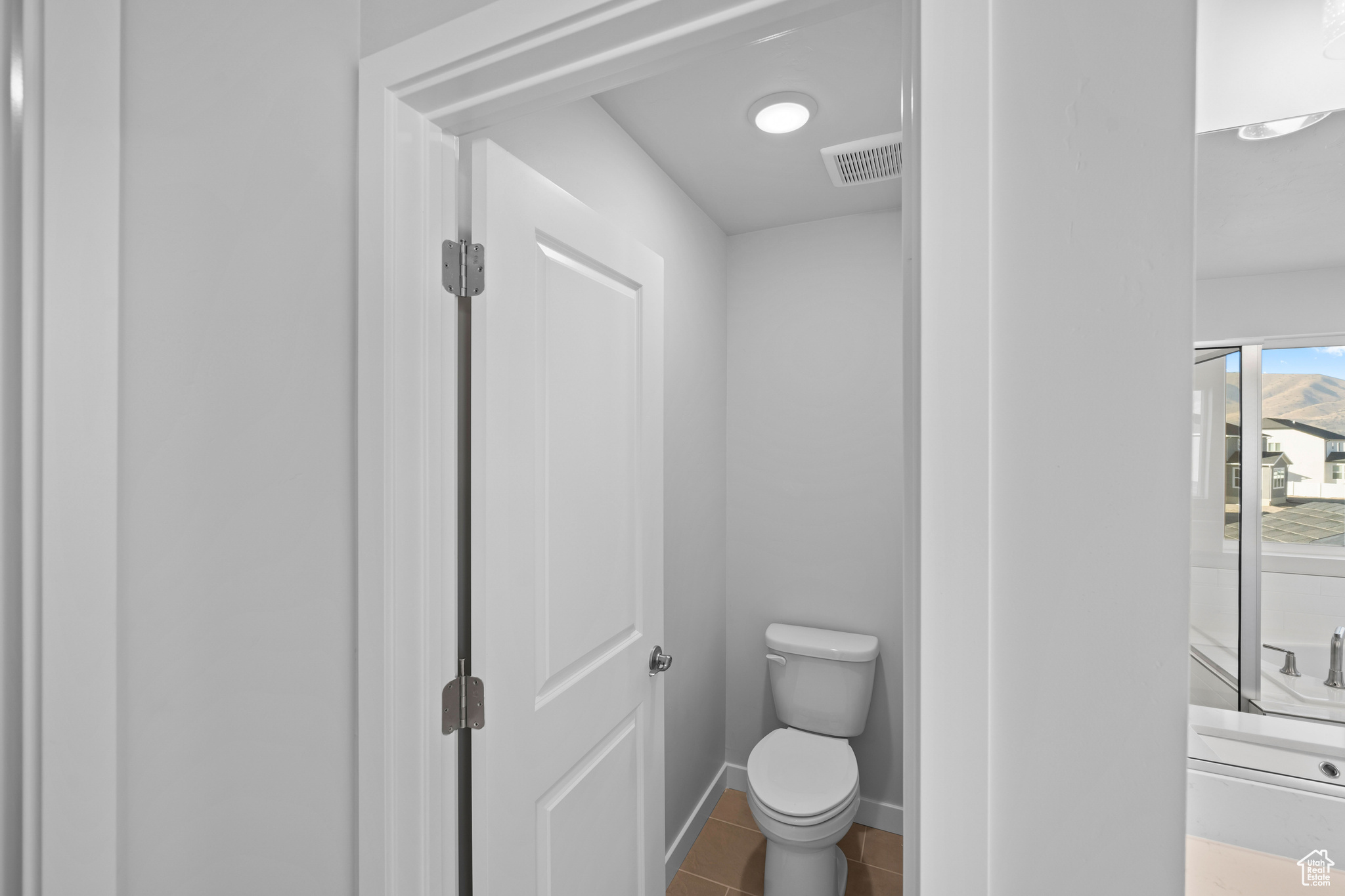 Bathroom featuring tile patterned floors and toilet