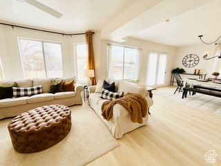 Living room featuring an inviting chandelier and wood-type flooring