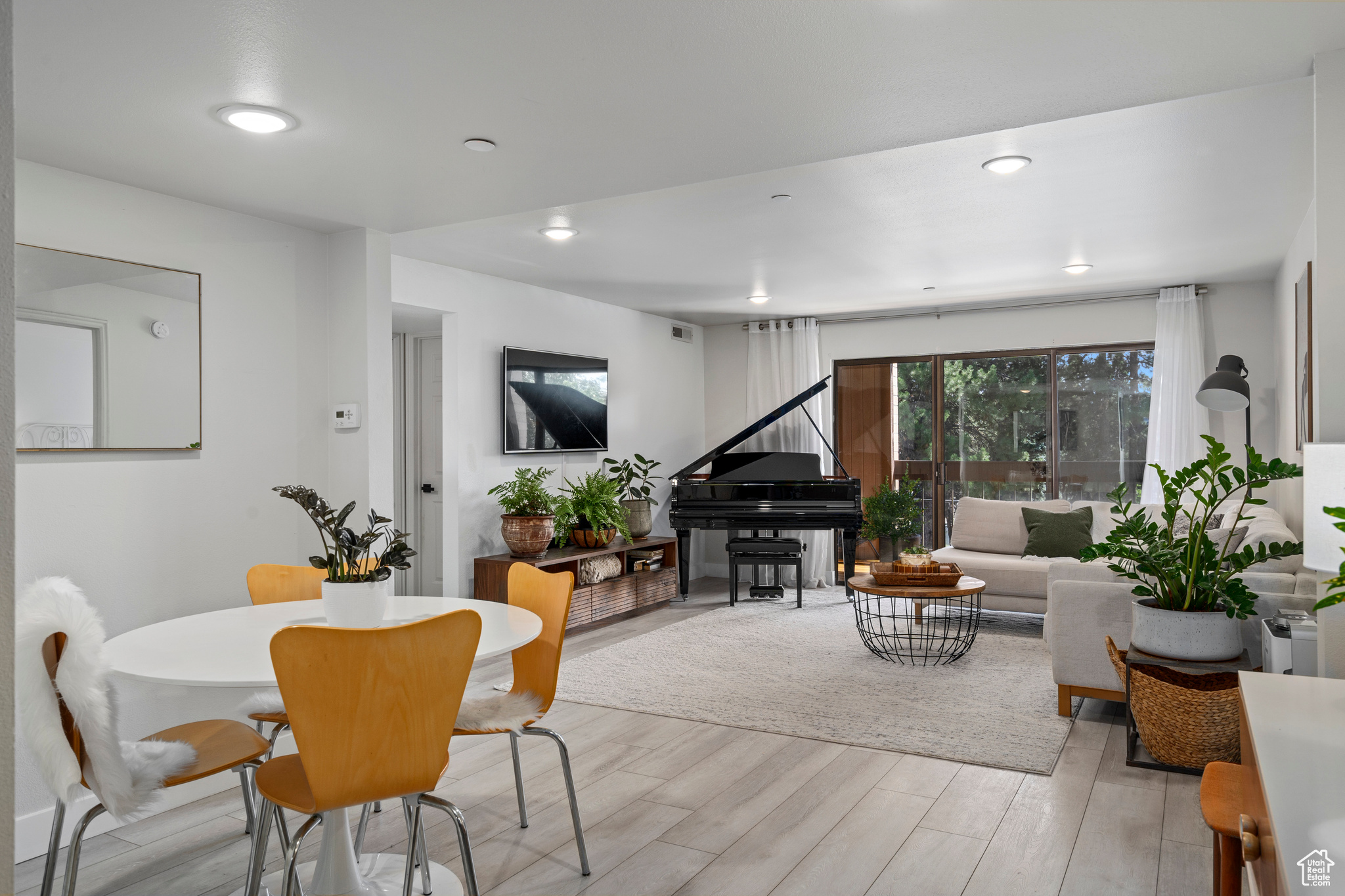 Dining space with light hardwood / wood-style flooring