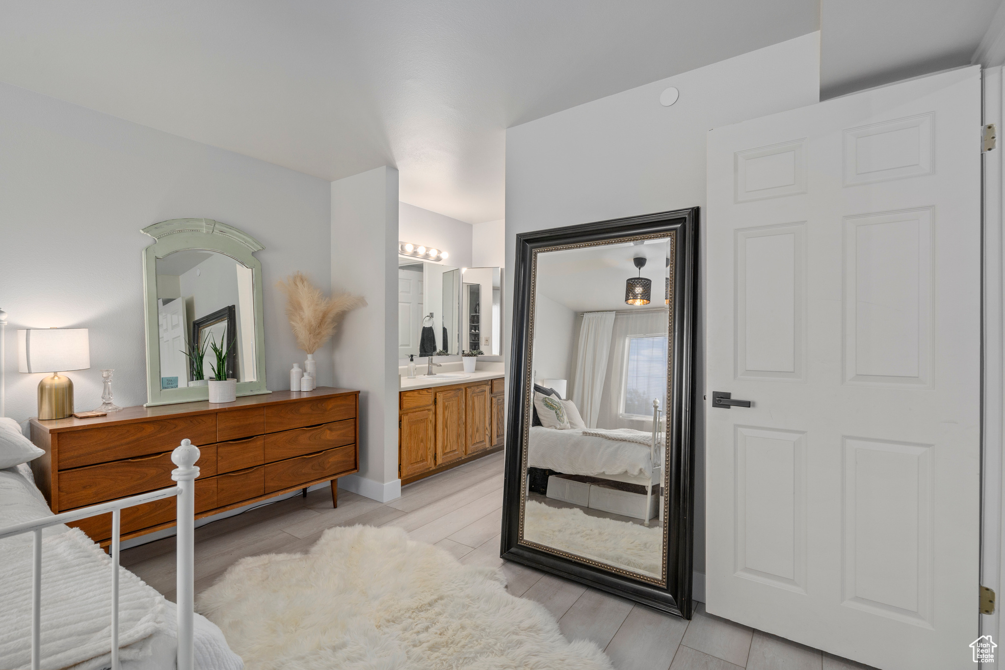 Bedroom featuring ensuite bath and light hardwood / wood-style flooring