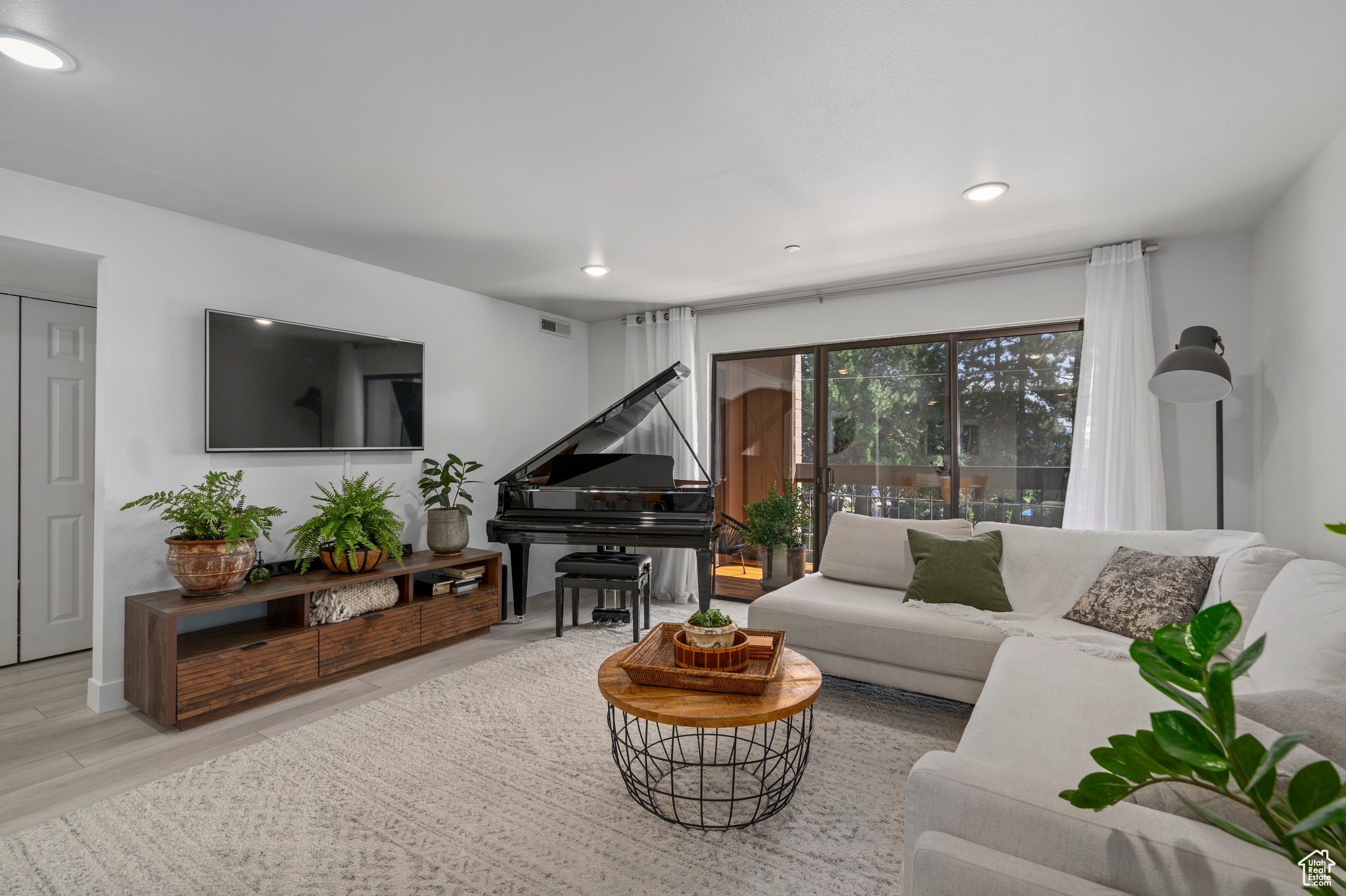 Living room with light hardwood / wood-style flooring