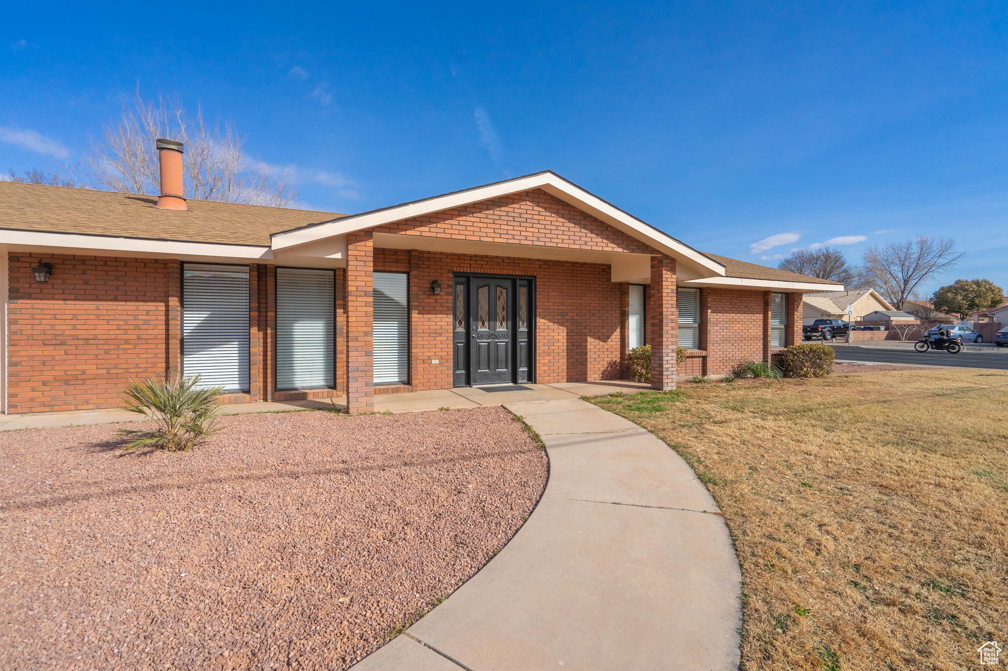 Single story home with a front lawn