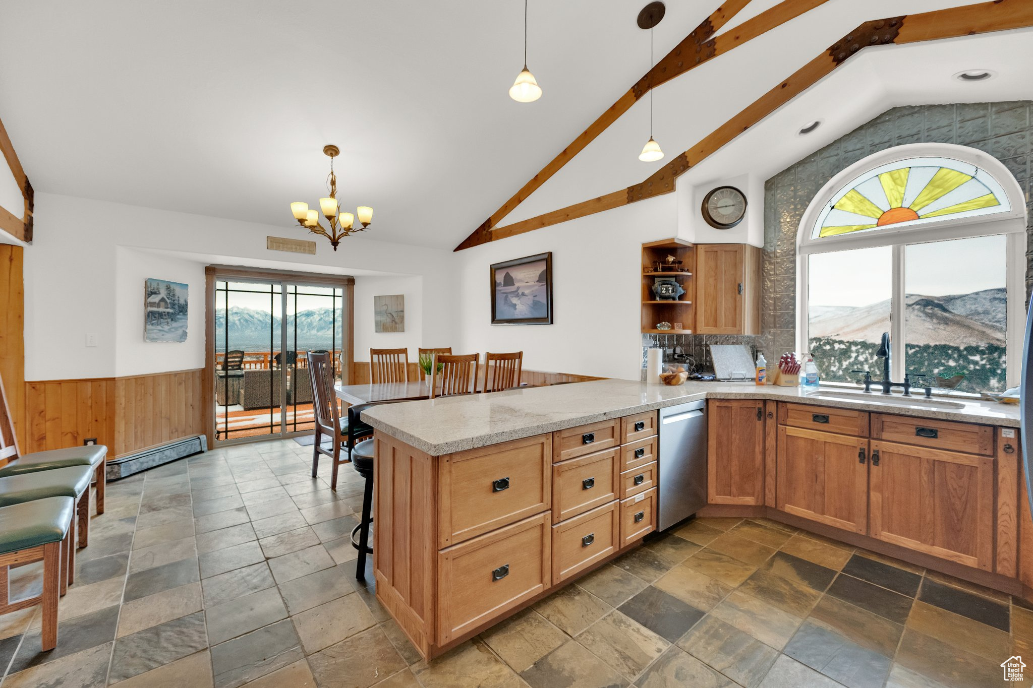 Kitchen featuring dishwasher, hanging light fixtures, a baseboard heating unit, kitchen peninsula, and a mountain view