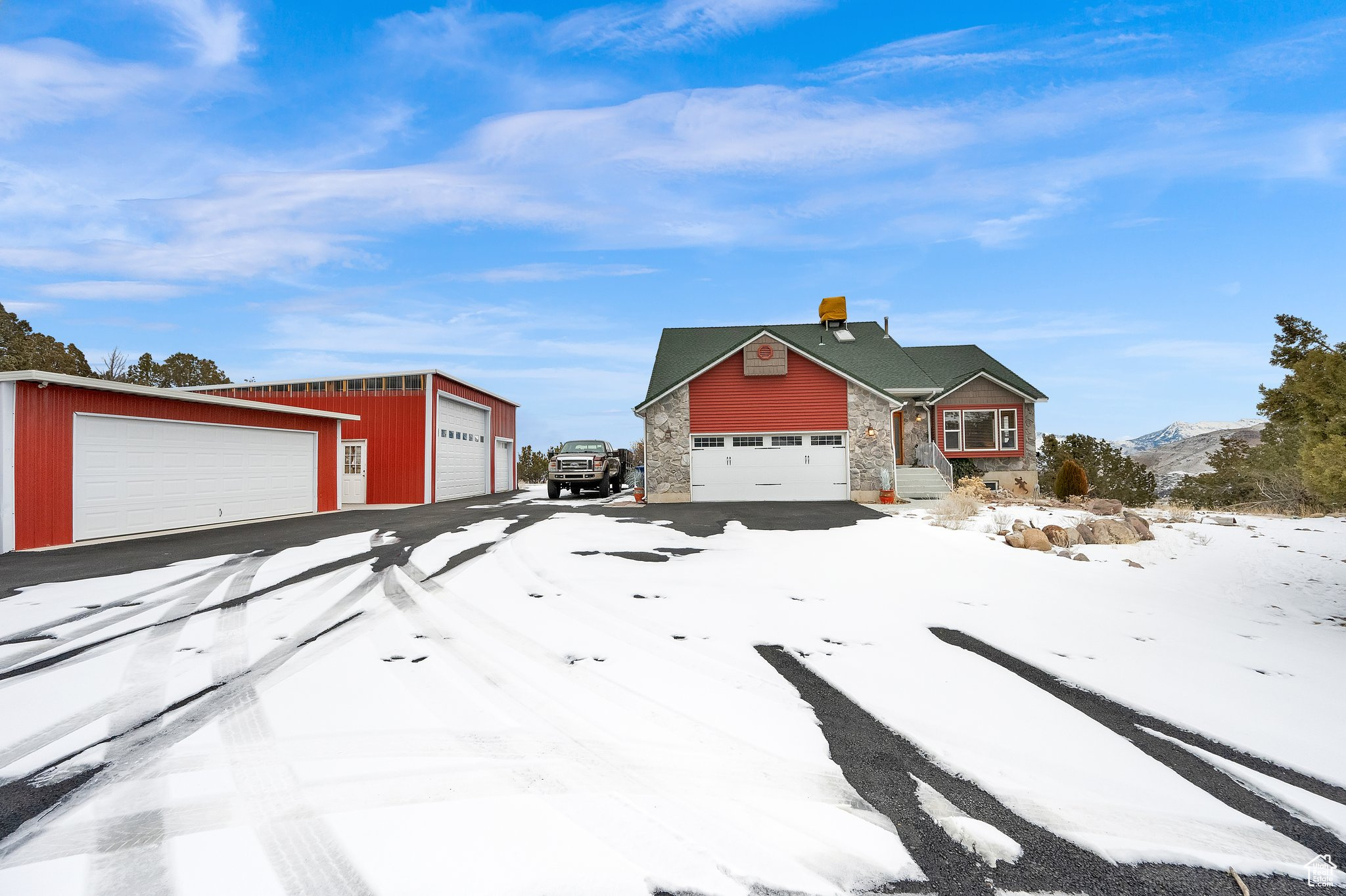 View of front of house with a mountain view and a garage