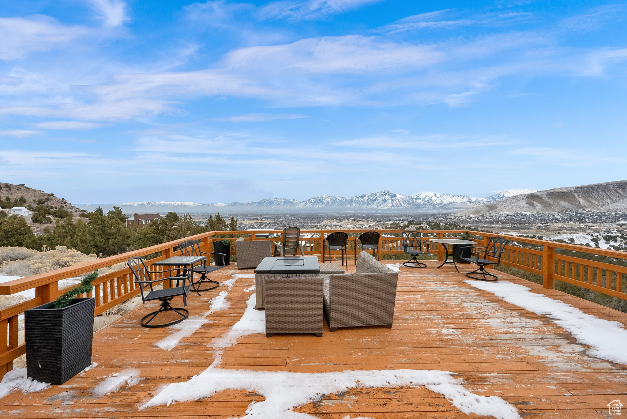 Snow covered deck featuring a mountain view and an outdoor living space