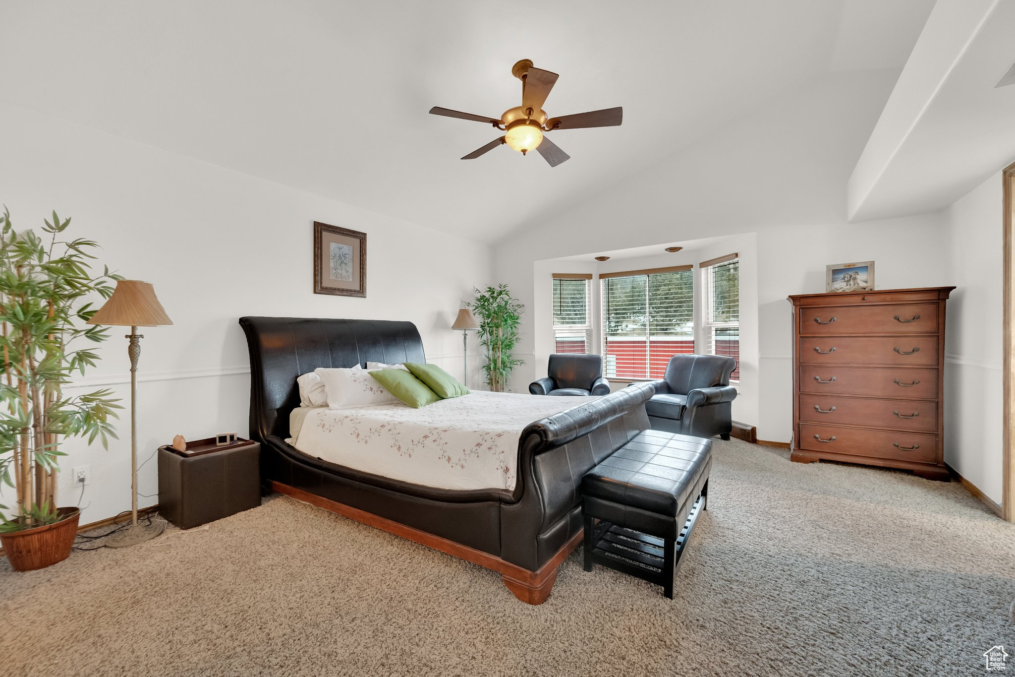 Bedroom featuring lofted ceiling, light colored carpet, and ceiling fan