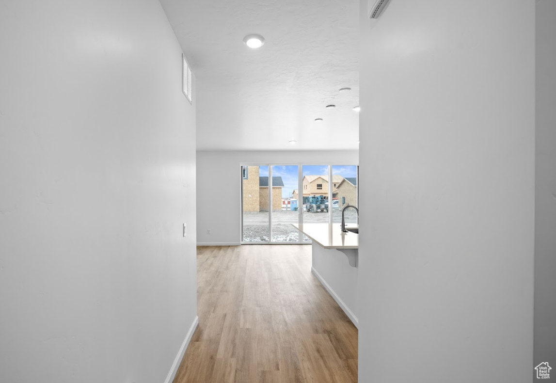 Entry corridor featuring light LVT flooring