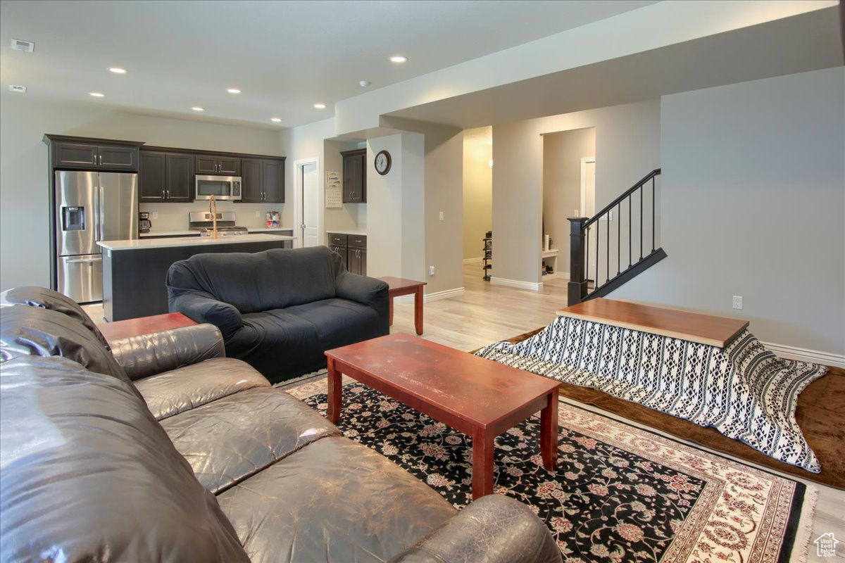 Living room with light hardwood / wood-style floors